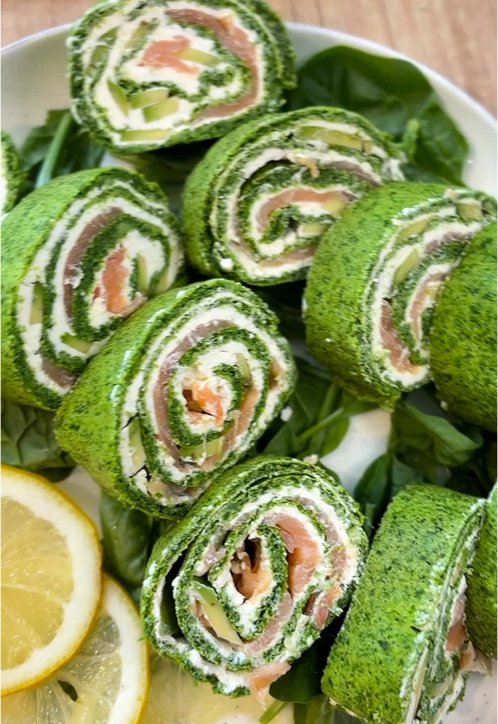 150 g spinach  • 3 eggs  • 50 g flour  • A pinch of salt  • 15 g sugar  • 200 g lightly salted salmon  • 200 g cream cheese  • 1 ripe avocado  Method :  1. Boil the spinach in water, then drain it well.  2. Let the spinach cool, then add the 3 egg yolks and blend until smooth.  3. In a separate bowl, beat the egg whites with a pinch of salt for about 1 minute. Add the sugar and continue beating until stiff peaks form.  4. Gradually fold the egg whites into the spinach mixture, stirring gently from bottom to top.  5. Add the flour and mix carefully until fully combined.  6. Pour the mixture onto a baking tray lined with parchment paper and bake at 180°C (356°F) for 10–13 minutes.  7. While still warm, roll the baked layer into a roulade (with the parchment inside), then let it cool completely.  8. Unroll the cooled base, spread the cottage cheese over it, then place the salmon and sliced avocado near one edge (not over the entire surface).  9. Roll it up tightly, wrap in cling film, and refrigerate for a few hours—or ideally overnight—to allow the flavors to meld.#Recipe #delicious #EasyRecipe 