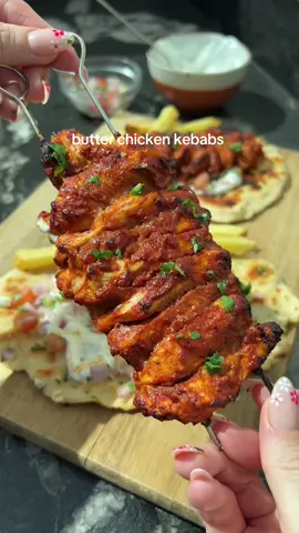 Butter Chicken Kebabs 😍 The ultimate sunshine dinner is here with these juicy, high protein butter chicken kebabs served with homemade garlic and coriander naan and a fresh yoghurt dressing 😮‍💨 BANGIN  ‼️ For more quick and easy meal ideas grab my cookbook “Low-Cal Kitchen Bangers” in my bio💕 Ingredients (serves 2): Marinade:  300g thinly sliced chicken breast ½  tbsp garam masala  1 tsp paprika  1 tsp ground cumin  ½ tsp ground coriander ¼ tsp ground turmeric 2 tbsp fat free greek yoghurt  10g reduced fat butter 1 tbsp tomato puree 1 and ½ tsp chopped garlic  ½ lemon juiced  Homemade naan: 100g self raising flour  110g fat free thick greek yoghurt  10g reduced fat butter  ½ tsp chopped garlic  2 sprigs of fresh coriander chopped  Garlic yoghurt sauce: 60g greek yoghurt  ½ tsp chopped garlic  Tsp lemon juice  Pinch of salt  1 sprig of fresh coriander chopped  To assemble: 4 cherry tomatoes quartered ½ small red onion diced  A couple of sprigs of fresh coriander chopped 80g frozen fries (optional)  💕 Add all of the marinade ingredients to a bowl.  Mix well before covering. Leave to marinate for a minimum of 1 hour.  💕Make the garlic yoghurt sauce and pop in the fridge. 💕Once ready to cook, make the naan by combining the flour and greek yoghurt. Split into two and set to one side. 💕Next, thread the chicken onto skewers. Air fry for 12-15 minutes at 200 degrees celsius, turning part way through.  💕Cook the fries according to instructions.  💕Roll the dough balls on a floured surface. Transfer to a hot pan. Cook on each side for 3-4 minutes on one side before flipping for a further 2 minutes.  💕Mix together the butter garlic and coriander. Brush over the naan on one side, flip for one more minute before removing from heat. 💕Spread over the garlic yoghurt sauce made earlier, before adding the cherry tomatoes, red onion and coriander. Top with the cooked chicken skewer and fries if using. Calories per portion: 595* (541 without fries) l Protein: 50.15g l Fat: 14.2g l Carbs: 53.5g  • • _________ #highproteinmeals  #DinnerIdeas #EasyRecipes #kebabs #butterchicken #lowcaloriemeals 