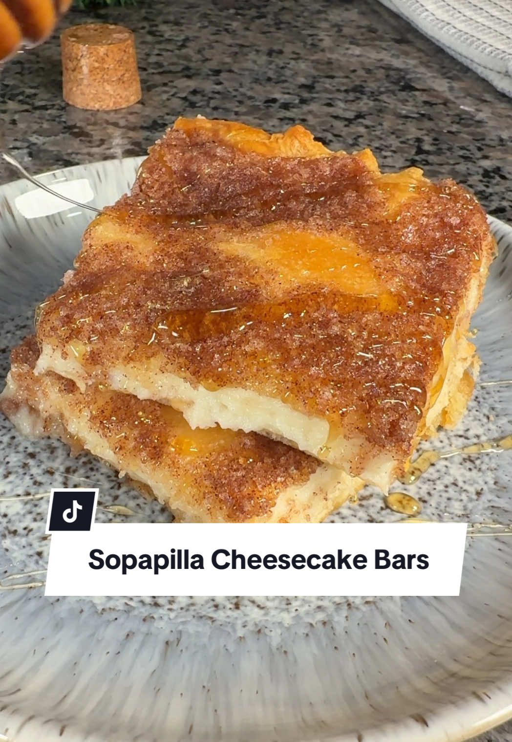 Your kitchen is about to smell amazing! 🤗 Sweet and simple, these Sopapilla Cheesecake Bars will become your new favorite dessert! Continue reading or click the link in the @allrecipes bio for the full recipe! 🔗 Ingredients: cooking spray 2 (8 ounce) packages cream cheese, softened 1 ¾ cups white sugar, divided 1 teaspoon Mexican vanilla extract 2 (8 ounce) cans refrigerated crescent rolls ½ cup butter, room temperature 1 teaspoon ground cinnamon ¼ cup honey Directions: Gather all ingredients. Preheat the oven to 350 degrees F (175 degrees C). Grease a 9x13-inch baking dish with cooking spray. Beat cream cheese, 1 cup sugar, and vanilla extract in a bowl until smooth. Unroll crescent roll dough, and use a rolling pin to shape each sheet into a 9x13-inch rectangle. Press one piece into the bottom of the prepared baking dish. Evenly spread cream cheese mixture on top. Cover with remaining piece of crescent dough. Mash remaining 3/4 cup sugar, butter, and cinnamon with a fork until combined. Dot mixture over top of dough. Bake in the preheated oven until crescent dough has puffed and turned golden brown, about 30 minutes. Remove from the oven and drizzle with honey. Cool cheesecake completely in the pan for about 2 hours before cutting into 12 squares. 🧑‍🍳:@Cory Armstead  #cheesecake #desserts #honey #cheesecakerecipes #easydesserts #sopapilla #cheesecakebars 