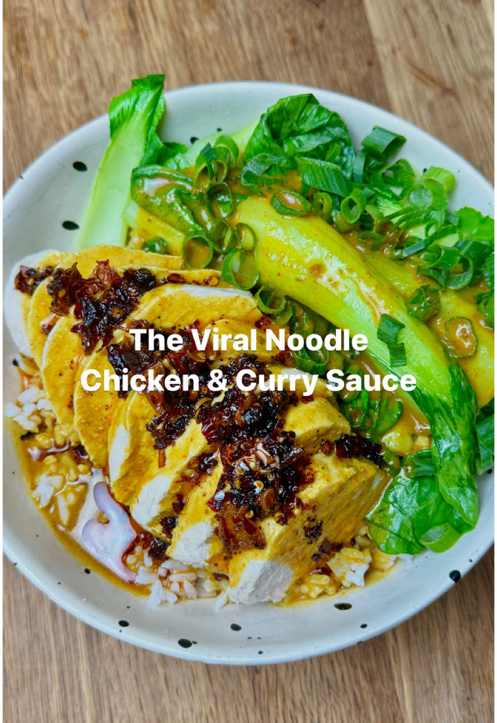 CHICKEN WITH CURRY SAUCE 🥘 Remaking the viral chicken and curry sauce from Noodle in Broadbeach, Gold Coast.  Ingredients for 2:  Bok choy  Chili crisp oil  Greens of the spring onions  1 cup rice  Chicken:  2 medium chicken breasts (or 1 large one)  1.5 cups water  1.5 cups chicken stock  2 garlic cloves  3-4 bay leaves  Curry sauce:  2 tbsp Ayam yellow curry paste  2 tbsp unsalted butter  1 tbsp fish sauce  1 tbsp soy sauce  1 tbsp sugar  1 tsp Keens curry powder  400ml coconut cream  Season this to YOUR liking! Season, taste, season taste  Method:  1. Wash your rice before adding two cups of water and placing it on the stove or in your rice cooker to cook.  2. In a cold pot, combine the water, stock, garlic and bay leaves before plunging the chicken breast into the liquid.  3. Pop the pot onto a medium heat and bring to a boil. Once boiling, lower the heat to the lowest setting possible and finish cooking for 5-7 minutes.  4. While the chicken is poaching, in a seperate pot, combine the ingredients for the curry sauce. Season and taste this as many times as you see fit until it’s exactly how YOU like it. Add more sugar if you like it sweeter, less curry paste if you don’t want it as aromatic or fragrant, more soy if you want it saltier etc etc.  5. Once the chicken is finished cooking, remove from the water and allow to rest before slicing.  6. Add the bok choy into a steamer and place the steamer over the pot with the water used to poach the chicken over medium to high heat and allow the steam to cook the bok choy (or chuck it in the water if you’re lazy, who cares).  7. Once all components are ready, assemble and serve topping with the greens of the spring onions and a healthy serving of both the sauce and chilli crisp.  #noodlebroadbeach #chickencurry #EasyRecipes #chickenandcurrysauce #chickendinner #DinnerIdeas #poachedchicken