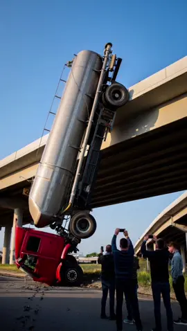 The fuel tanker fell from the bridge—but instead of tipping or exploding, it landed perfectly upright, stuck in place like a sculpture of chaos. No fire, no injuries—just disbelief at how precise disaster can look #crash #crashed #damage #ai #news #dtp #car #track #bridge #police #collapse #fueltank #chaos