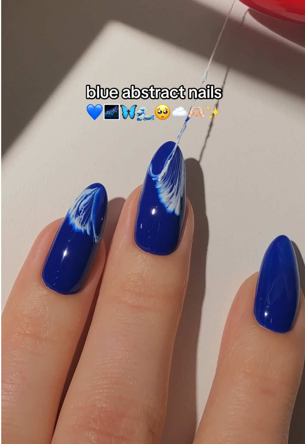 blue abstract swirl nails! 💙🦋🌌 i remember seeing this technique used on abstract paintings all over social media a few years back & i can’t believe i have never tried to use it for a nail design before! it turned out much more beautiful than i ever expected! <3 📍let me know which art technique/old nail art trend i should try next!  — using: • @melodysusie  dark blue gel polish “Persian Blue” 🌌 white gel polish “Snow White” ☁️ jelly blue jeweliver gel “Blue Tanzanite” 💙 hema-free gel top coat! ✨ (use my code nailsbypaular12 for 12% off! 💸) #bluenails #abstractnails #abstractart #nailartinspo #nailarttutorial #coolnails #nailideas #nailinspo #diynails #naildesign #nails2inspire #nailart #nailartist #fypシ゚ 