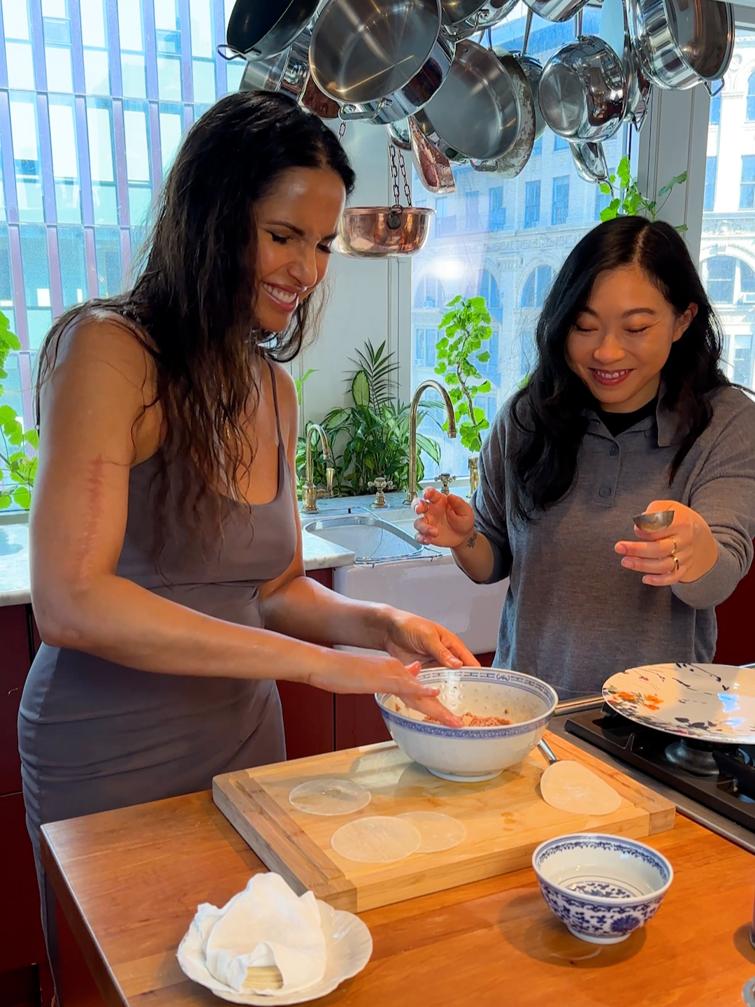 Back in the kitchen once more with @awkwafina to make pork dumplings with water chestnuts and dates from my upcoming cookbook Padma's All American! Though it was more chaotic than it should be in this video, the sear-and-steam method is the best way to both preserve the flavor and moisture inside the dumpling, while creating a perfect bronzed bottom that you see at the end. Don't forget to pre-order Padma's All American so that you can try these for yourselves! I want to see all the bronzed bottoms!! #dumplings #cookwithfriends #chezlakshmi #recipe #padmasallamerican