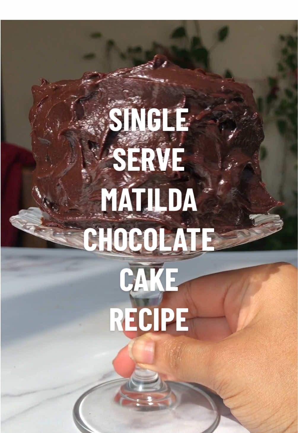 Replying to @Betty Crocker SINGLE SERVE MATILDA CHOCOLATE CAKE aka Bruce cake recipe🍫 you lot have gone crazy asking for this recipe so here it is in the caption, save it this video and find more details with substitutes etc on my blog. ingredients: chocolate cake - 75 gm flour 10 gm corn flour 35 gm cocoa powder 1/2 tsp baking powder 1/2 tsp baking soda 1/4 tsp salt 40 gm milk 1 tsp vinegar 35 gm vegetable oil 60 gm mayonnaise 1 egg 1 tsp vanilla 60 gm brown sugar 60 gm white sugar 80 ml hot water + 1 tsp coffee powder chocolate fudge frosting - 30 gm butter 50 gm dark chocolate 100 gm heavy cream 30 gm icing sugar 15 gm cocoa powder Pinch of salt method:  🍫Preheat the oven to 180℃, line two 5 inch tins with baking paper and brush with oil, set aside. 🍫In a small mixing bowl add the flour, cocoa powder, baking powder, baking soda, salt and mxi together until combined. In a small glass add the milk and vinegar, stir and set aside. 🍫In another bowl add the oil, mayonnaise, egg and whisk. Add the white, brown sugar, vanilla and whisk. Add the milk mixture and whisk. 🍫Add half the dry ingredients and mix until partially combined, add the hot coffee and mix until smooth. Add the remaining dry ingredients and mix until combined. 🍫Divide the batter between the tins and bake for 19-21 minutes until risen and tooth pic inserted into the center comes out clean. 🍫While this is happening let us make the frosting by adding all the ingredients into a heavy bottom sauce pan and placing on low heat. Stir well making sure the chocolate is melted and the mixture is smooth, do not over cook and take it off the heat. let it cool completely (around 1 hour). 🍫Once the cakes are done remove from the tin and let them cool completely before frosting. After the cake is cooled place one cake on a plate and top with the frosting that should now be thick and spreadable. Spread the frosting evenly over the cake and place the next cake on top. Frost the top of the cake and he sides in a rustic swirl like manner. 🍫Slice and serve or just bite into it directly. #matildachocolatecake #matildacake #brucecake #singleserve #singleserving #singleservedessert #chocolatecake #chocolatelover #chocolaterecipe #homemade #caketiktok #caketok #baking #bakingtiktok #bakingszn #fyp #fy #viral #bakersoftiktok  Matilda chocolate cake, chocolate cake, single serve Matilda chocolate cake, single serve cake, Bruce chocolate cake, Bruce cake, single serve chocolate cake, baking, baking recipe 