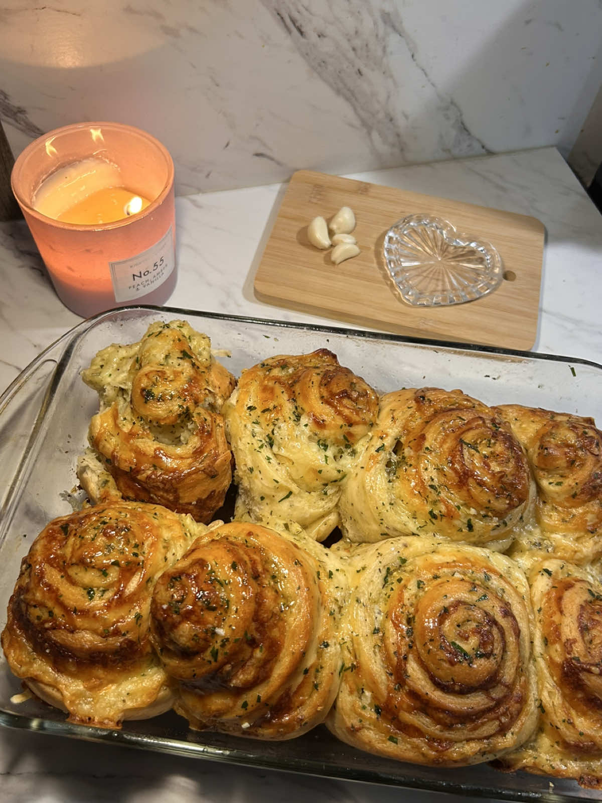 homemade cheesy garlic bread rolls🤎   recipe:    dough: 1 cup warm water (240g) 1 packet of yeast (7g) 2 tbsp sugar (25g) 1/4 cup melted butter (57g)ygarlic rolls 1 egg (room temp) 3 cups of flour ( or keep adding until it’s no longer sticky) 1/2 tsp garlic powder (1.6g) 1/2 tsp oregano, basil, & parsley (0.5g) 1/4 tsp onion powder (0.6g) 1 tsp salt (6g) activate the yeast in warm water with sugar and let it sit until foamy. mix in the butter, egg, and seasonings. Add flour gradually and knead until smooth. cover, & let the dough rise until doubled. ( about 1 hr )   filling: 1/2 cup butter (room temp) (113g) 8-10 garlic cloves, minced (24-30g) 1 tsp fresh parsley (1g) 1/4 tsp basil & oregano (0.3g) mix the filling ingredients in a bowl. roll out the dough into a rectangle, spread the filling evenly, then roll it up and slice. place slices in a baking dish and let rise again for about 15 minutes. (i recommend parchment paper under the rolls so the bottom doesn't stick!) bake at 350•F for about 25-35 minutes. brush leftover butter mixture onto rolls while warm & enjoy! :) #cheese #garlicrolls #Recipe #bread #bakingrecipe #baking  #fyp 