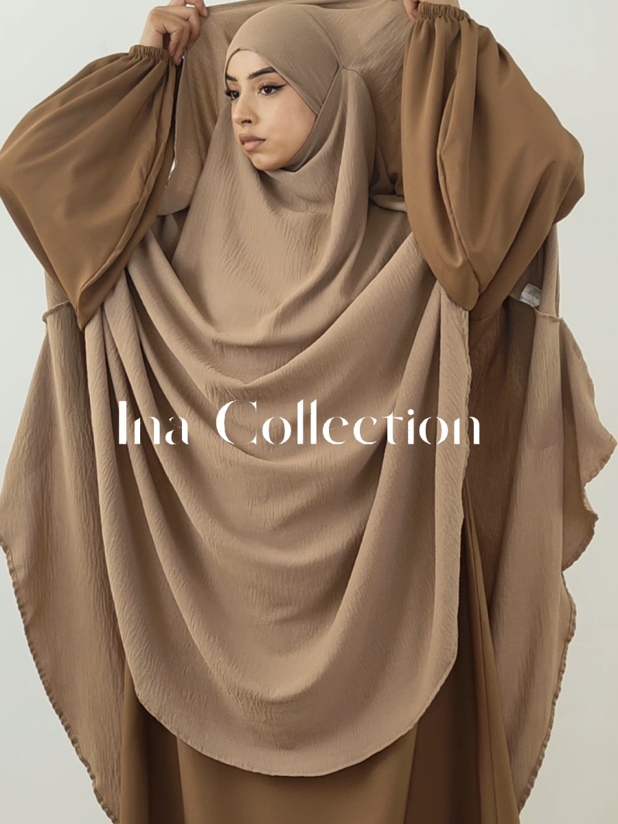 🤎Sutra Maxi Khimar Cape Jazz Camel🤎 ⭐(Pair with abaya Soumaya)⭐ Sutra Maxi Khimar cape in Jazz. Full-coverage outfit in a maxi cape style. Designed with side flaps for added coverage and modesty. Crafted from lightweight, textured Jazz fabric for comfort and breathability. Loose, flowing fit perfect for everyday wear or special occasions. Elegant, modern and modest stylish appearance. Provides complete, modest coverage. Available in different colours. . . #KhimarStyle #ModestKhimar #KhimarFashion #KhimarLook #KhimarOutfit #KhimarGoals #ModestWear #CoveredWithStyle #ModestChic #MuslimahStyle #FaithAndFashion #HijabAndKhimar #KhimarLover #ModestButStylish #ModestWardrobe #LayeredModesty #KhimarVibes #IslamicWear #ModestyMatters #ModestAesthetic 
