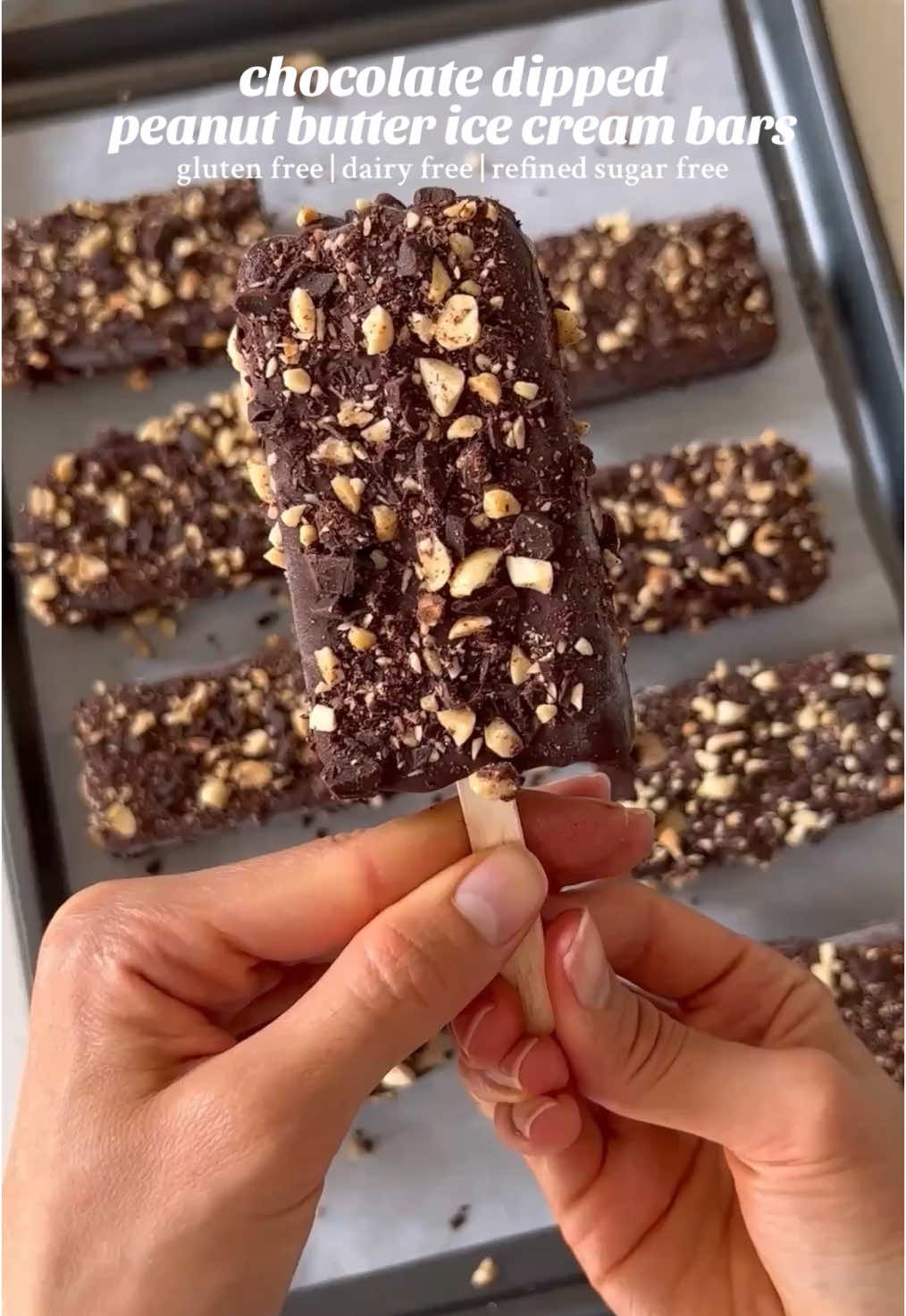 Chocolate dipped peanut butter ice cream bars! They’re gluten free, dairy free, and refined sugar free, and sooo delicious.  Peanut Butter Ice Cream: •1 (13.5oz) can full fat canned coconut milk •1/2 cup natural peanut butter (or 1 cup peanuts) •1/2 cup pure maple syrup (or raw honey) •1 tsp pure vanilla extract •1/4 tsp salt (use 1/8 tsp if using salted peanut butter/peanuts) Chocolate Shell: •9oz dark or semi-sweet chocolate (I use dairy free & refined sugar free chocolate) •2 tbsp coconut oil Topping: •1/2 cup peanuts •3oz dark or semi-sweet chocolate (I use dairy free & refined sugar free chocolate) Instructions: 1. Add all of the ice cream ingredients to a high speed blender and blend until smooth. 2. Pour the ice cream mixture into 8-10 silicone popsicle molds and place in the freezer overnight, or for at least 8+ hours. They should be frozen solid.  3. Once the ice cream bars are frozen, finely dice some chocolate and peanuts for the topping. Next, melt the chocolate and coconut oil together for the chocolate shell (in the microwave or on the stovetop using the double boiler method). 4. Take the ice cream bars out of the freezer and remove from the molds (I find it helps to push them out of the molds from the bottom).  5. Coat each bar in melted chocolate then sprinkle with chopped chocolate and peanuts. Place the ice cream bars on a tray lined with parchment paper and place back in the freezer until the chocolate shell hardens. 6. Once the chocolate shell has hardened, remove from the freezer and enjoy (I like to let them sit out for 5-10 minutes before consuming so the ice cream filling is softer).  #healthyicecream #veganicecream #frozendessert #homemadeicecream #dairyfreedessert #refinedsugarfreetreats #peanutbutterchocolate #healthydessert #glutenfreedessert 