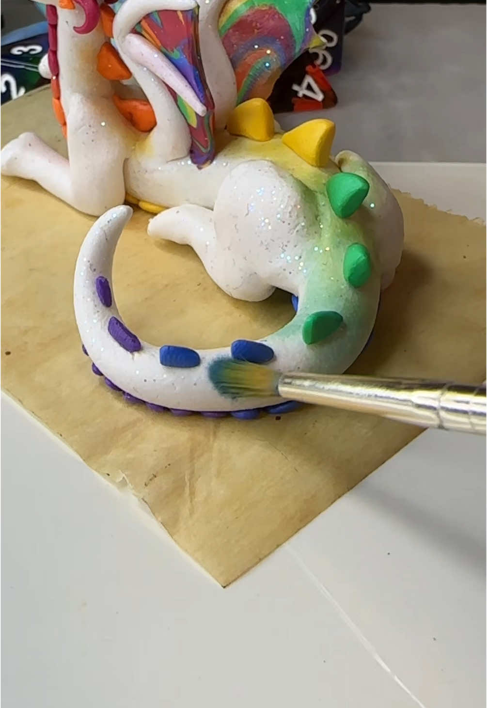 I promise that roll was real, I’m just built different. #dragon #dragons #dice #dicedragon #rpg #rpgdice #diceset #clay #claydragon #polymerclay #polymerclaydragon #polymerclayart #art  Seriously do tags do anything #clayart #artist 