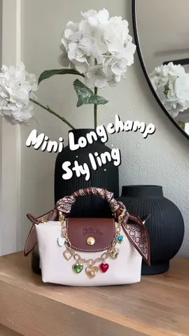 Let’s style my mini Longchamp le Pliage 💕 ordered this little strap adapter set to be able to attach a cute bag charm and I am obsessed. Plus some cutie little scarves I found on Amazon, it’s so easy to dress up this mini bag and customize the look. I’ve been carrying this bag so much lately, it’s surprisingly spacious and matches everything. Linked everything on my ShopMyLTK/Amazon sf! #creatorsearchinsights #longchamp #longchamplepliage #longchampmini #longchampbag 