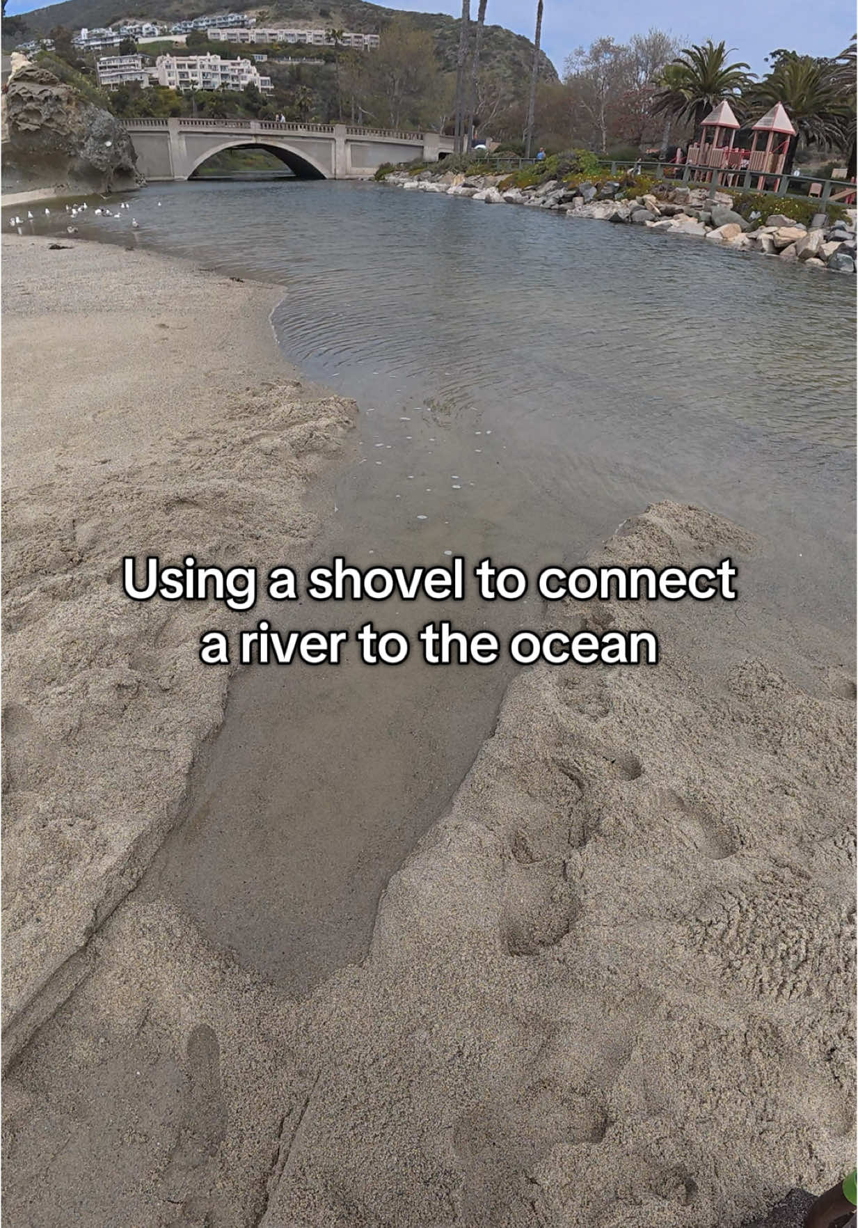 Connecting a lake to the ocean with a shovel
