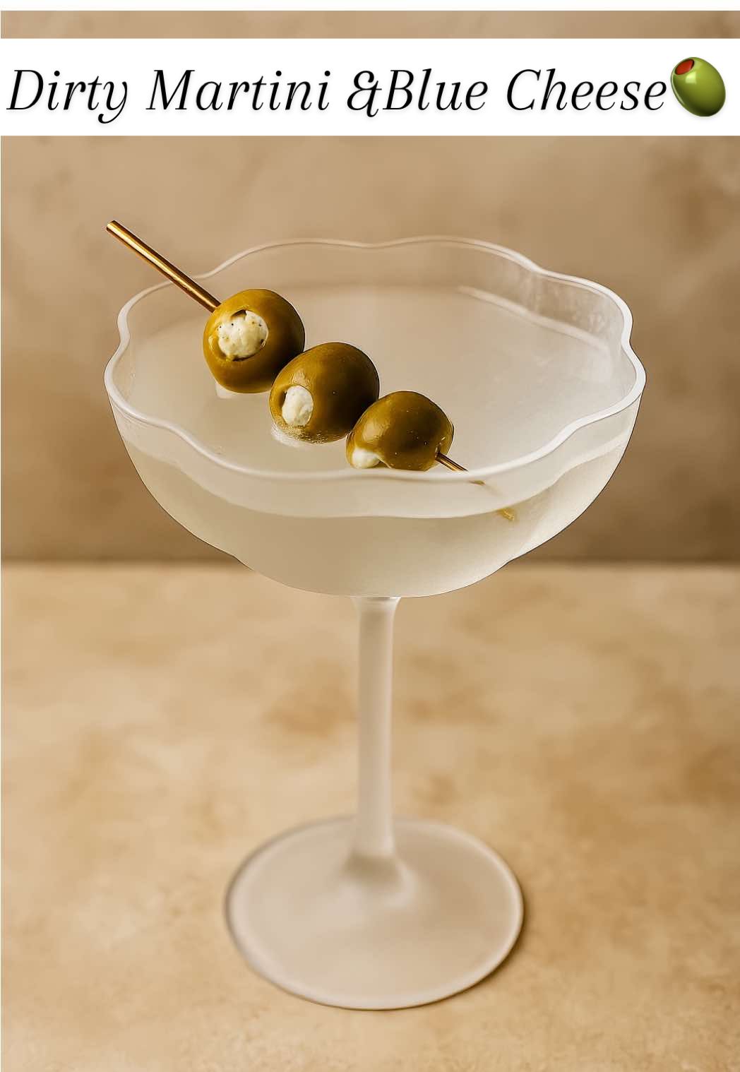 Classic 🍸🫒🧀 Dirty Martini with Blue Cheese Stuffed Olives Recipe -3 blue cheese-stuffed olives -1 ounce dry vermouth (mix 1/2 ounce with blue cheese to stuff olives) -2 ½ ounces vodka (or gin) ½ - 1 ounce olive brine 1. Pour 1/2 oz of vermouth in a cocktail glass, swirl, and then mix a couple tablespoons of blue cheese with the 1/2 oz vermouth. Stuff olives and chill in fridge.  2. Place vermouth lined glass in freezer to chill.  3. Combine vodka or gin, remaining 1/2 oz vermouth, olive brine, and ice in a large shaker. Shake well, until the shaker is chilled. 4. Strain into the prepared cocktail glass, and serve with the blue cheese-stuffed olives. One is all you need! You’re welcome. 🍸 #dirtymartini #bluecheeseolives #classicmartini #classiccocktails #martinirecipe #easycocktailrecipes #tinitime #lowcarbcocktails 
