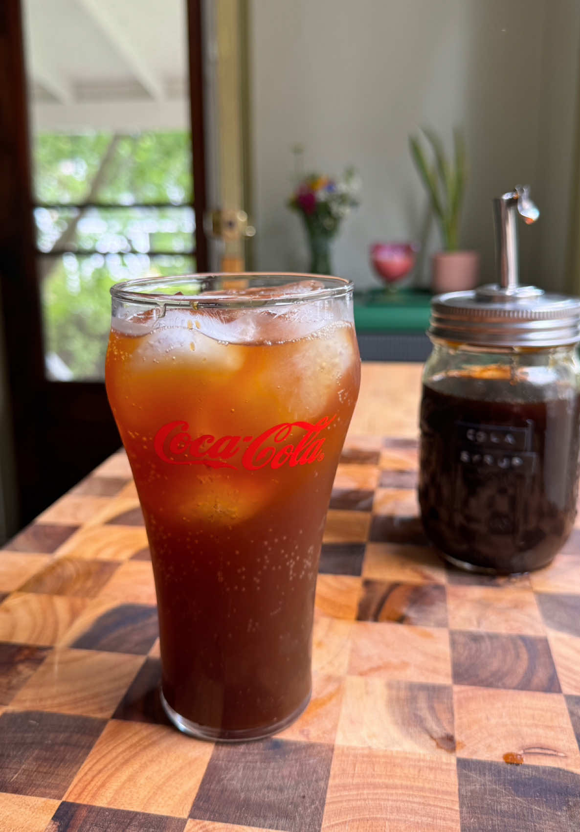 COCA COLA FROM SCRATCH 🙂‍↕️🥤 using simple ingredients like coconut sugar, citrus, and spices!! I was genuinely so surprised by how much this tasted like cola!! But with no corn syrup or artificial ingredients🤝 (but don’t get me wrong, I love me a crispy Coke Zero from time to time) Were also not adding any phosphoric acid, which gives Coke that super crisp, tart flavor we all know & love, but still this hits the spot and is so fun + easy to make!  Cola Syrup Recipe  Ingredients  1 cup coconut sugar  1/2 cup water  1 cinnamon stick  1/2 inch piece of lemon, lime, and orange zest  1/2 tsp each coriander and nutmeg  1/2 tsp bitters  1 tsp vanilla  Directions  - In a saucepan, caremelize the coconut sugar over low-medium heat until it starts to get sticky. Then, pour in the water, stir, and bring to a simmer.  - Add in the zest, cinnamon stick, and spices. Continue to let simmer for about 5-10 minutes, or until it starts to thicken.  - Strain and stir in the vanilla + bitters.  - Store in the fridge for up to 2 weeks. Then, to make a cup of cola, use 1 part syrup to 3 parts seltzer. Stir and enjoy!!
