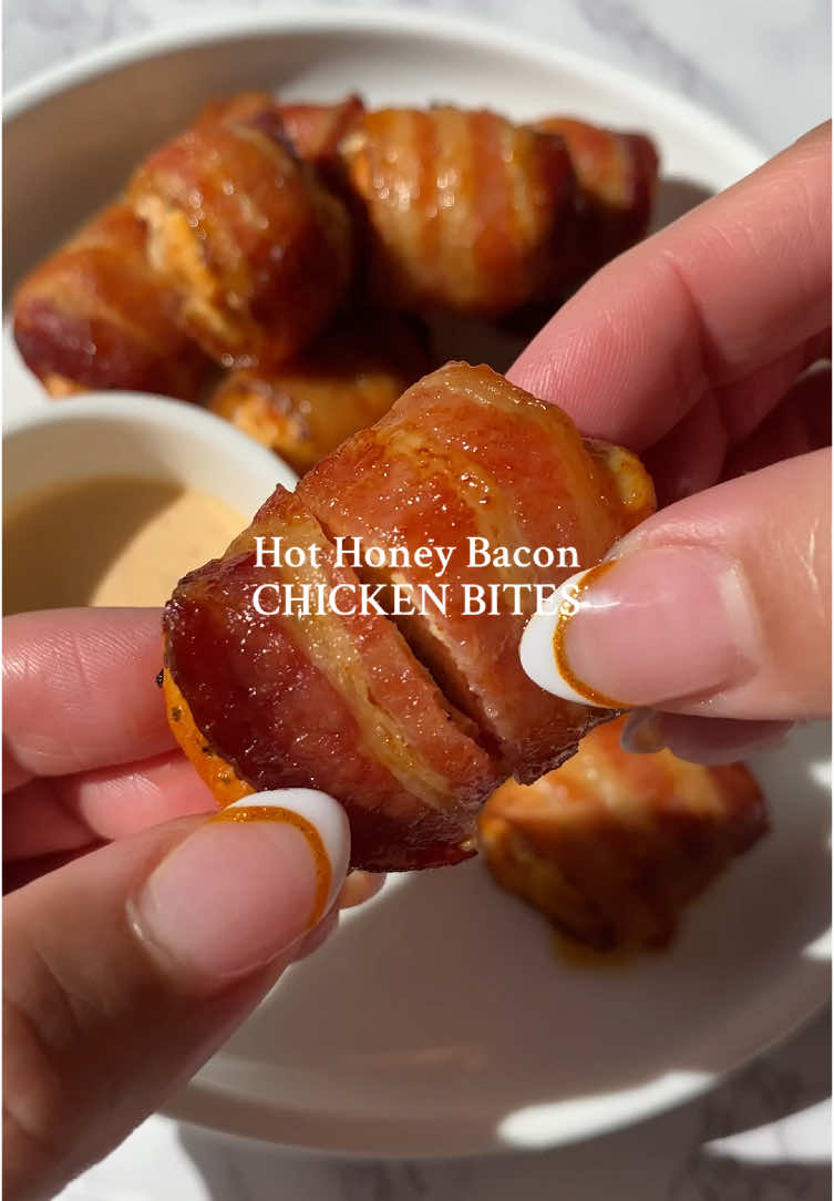 hot honey bacon chicken bites✨ if you're a fan of my bacon wrapped shrimp, you will LOVE these!  1. Cube 4 large chicken breasts (or thighs) into cubes and add to a bowl 2. Season chicken with 1tbsp garlic old bay (or garlic herb seasoning, 1tsp paprika & 1tsp olive oil 3. Cut bacon slices in half (the whole package) 4. Wrap each chicken with bacon slice 5. Add them to air fryer basket & air fry at 375 for 15 min 6. Top with a drizzle of hot honey 7. Serve with spicy mayo for dipping 8. Enjoy! xoxo #Recipe #EasyRecipe #DinnerIdeas #hothoney #airfryerrecipes #fyp 