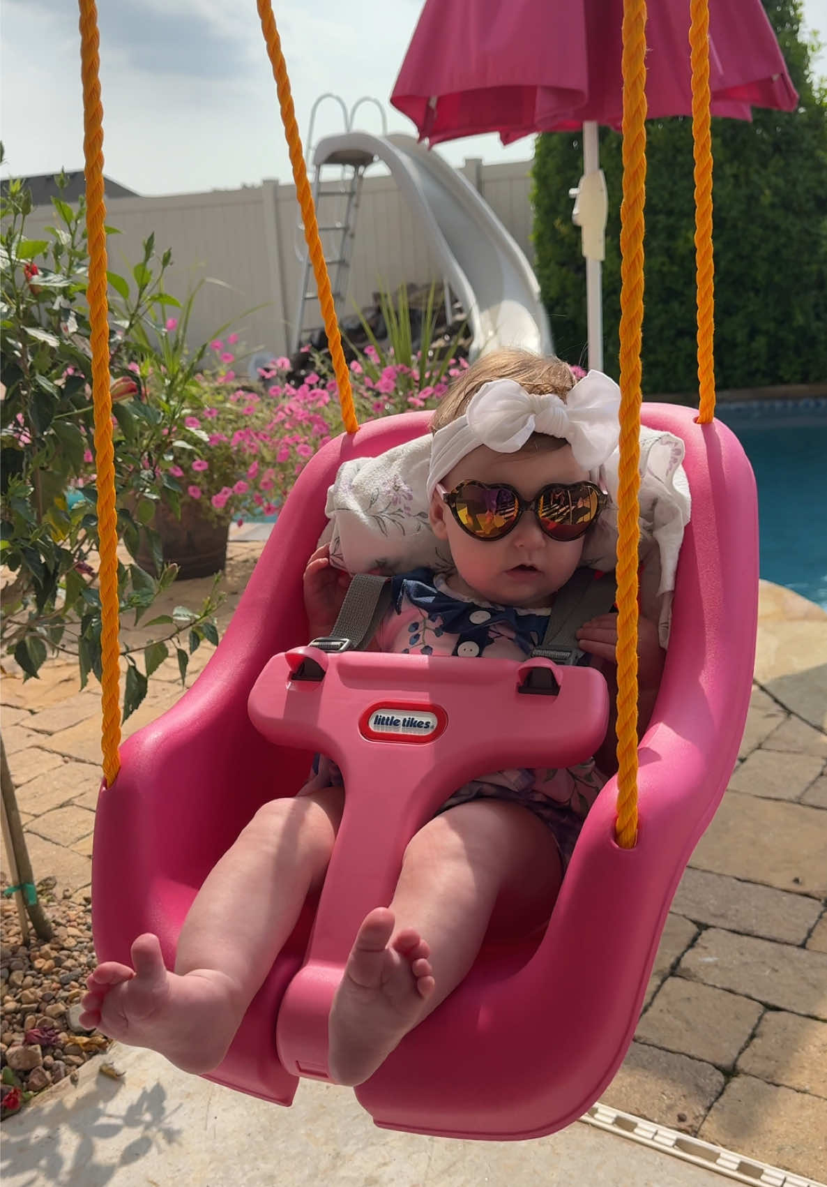 Bella just vibin 🌺 #babygirl #Summer #swing #babyfever #5monthsold #babybella🎀💜 #babybellanoelle #pink #barbie #flowers #pool #sunglasses 
