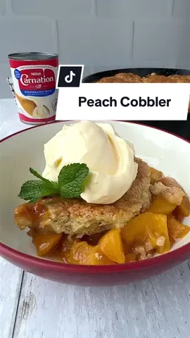 This peach cobbler recipe is perfect for the long weekend! 🍑 #peach #cobbler #peachcobbler #Recipe #Summer #recipes #memorialdayweekend #evaporatedmilk #recipe #carnationmilk #carnationnation  Peach Cobbler Ingredients Peach filling 2 ½ lbs fresh peaches, peeled and cut into 1-inch chunks* 3 Tablespoons brown sugar 2 teaspoons cornstarch 2 teaspoons lemon juice ¾ teaspoon vanilla extract ¼ teaspoon cinnamon Pinch ground nutmeg Pinch ground ginger ⅛ teaspoon salt *You may also substitute frozen peaches, just defrost, drain, and blot with a paper towel before chopping into one-inch chunks and using them in the recipe. Biscuit Topping 1 ¾ cup all-purpose flour 5 ½ Tablespoons granulated sugar 1 teaspoon baking powder Scant ¼ teaspoon baking soda ¼ teaspoon salt 6 Tablespoons unsalted cold butter, cubed 6 Tablespoons cold Carnation Evaporated Milk Egg wash: 1 large egg beaten with 1 Tablespoon Carnation Evaporated Milk Optional: 1 Tablespoon sugar mixed with ¼ teaspoon cinnamon Vanilla ice cream, for serving How to make peach cobbler: 1. Preheat the oven to 350 degrees. Grease a 9-inch cast-iron skillet or a 9-inch square baking pan with butter and set aside.  2. For the filling, whisk all of the dry ingredients together (cornstarch, brown sugar, salt, cinnamon, ginger, and nutmeg) in a large bowl. Add peaches, lemon juice, and vanilla, toss to combine until the peaches are coated. Pour into the prepared baking dish and bake for 10 minutes.  3. While the peaches bake, prepare the biscuit topping. 4. In a medium bowl, combine flour, sugar, baking powder, and salt. Whisk to combine. Add cubed cold butter. Using a pastry cutter or a few forks, cut the cold butter into the mixture until it resembles pea-sized crumbs. Pour in the Carnation Evaporated Milk and mix until evenly combined. If the mixture is still too dry, add another Tablespoon of Carnation so it can hold together in a shape. 5. Remove the peaches from the oven and place the skillet/pan on a rimmed baking sheet to catch any potential overflow. Take handfuls of the biscuit topping and gently flatten it into patties. Place the dough on top of the peaches so the surface area is covered. Prepare the egg wash. In a small bowl, whisk the egg and a tablespoon of Carnation evaporated milk until smooth. Using a pastry brush, brush the tops of the biscuits until evenly coated. Sprinkle the top of the biscuits with the cinnamon sugar mixture. Using oven mitts, place the cobbler back into the oven. 6. Bake the cobbler for 40-50 minutes until the peaches are bubbling and the biscuit topping is golden brown. To test doneness, stick a toothpick in the biscuit topping. It should come out clean. A few crumbs are ok. 7. Remove from the oven and allow the cobbler to cool for 5-10 minutes. Serve warm with vanilla ice cream and enjoy! 