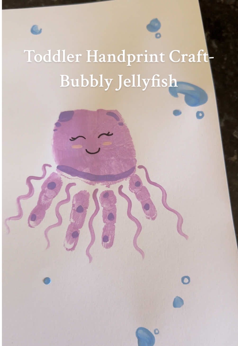Such a cute summer craft! We love our little jellyfish girl 🪼💜 #toddlercrafts #toddleractivities #toddleractivitiesathome #sensoryplay #summercrafts #preschoolactivities #craftymoms 