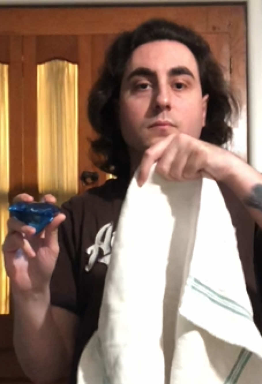 Large blue diamond becomes clear; magic trick by Mario magician; jumbo blue diamond magically becomes clear; performance by Mario magician.