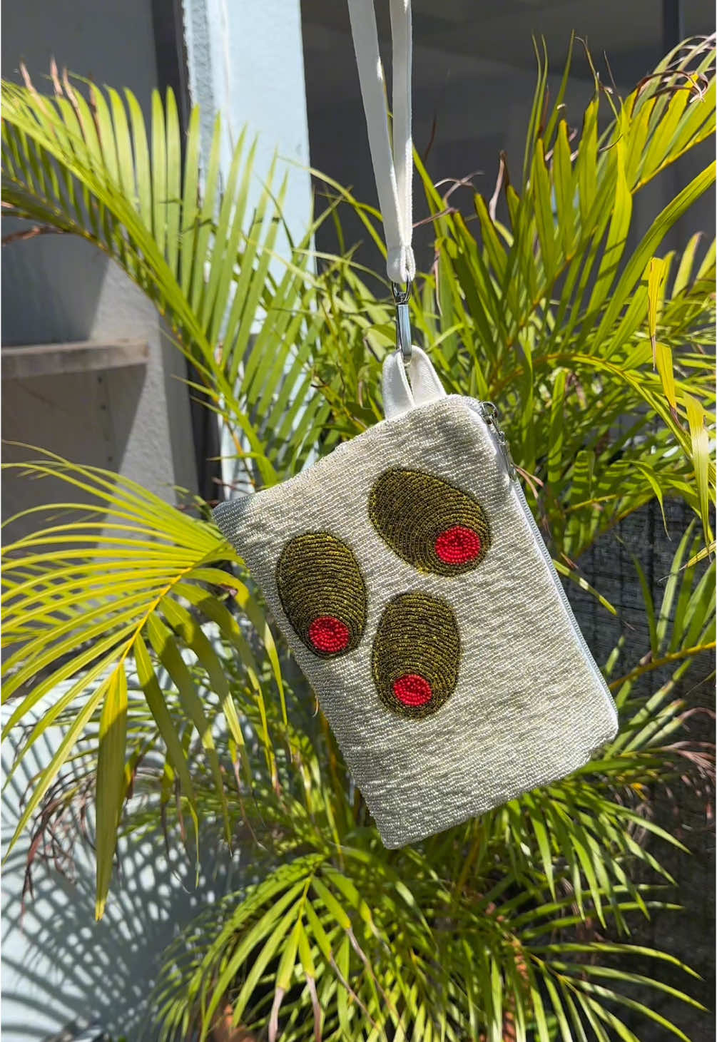 No women were harmed in the making of this bag. But seriously when a bag idea hits before 9am… you have to cancel your weekend plans. 40+ hours later, here’s a silver bag covered in GIANT PIMIENTO OLIVES. Beading is my new hyperfixation and obviously I had to fuse it with my first love: bag making. I’m completely obsessed and already planning the next ridiculous masterpiece. Follow along to see what I bead next—spoiler: it’s probably going to be unhinged. Beading, beaded embroidery, seed beads, bag making, beaded bag, beaded coin purse, diy.