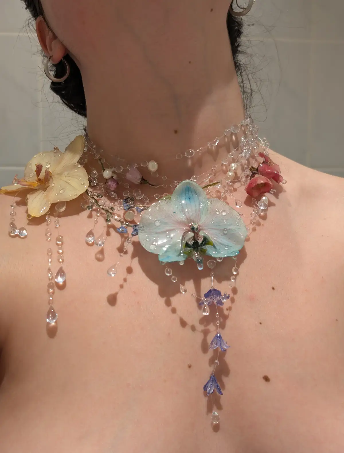 Next restock tomorrow Sunday at 3pm BST!!! I've made so many new flower necklaces for tomorrow's restock and many of them are orchids 🌸  I love all the blues and purples and I hope you love them too 💙🩷🩵  Let me know your favourite necklace or flower and maybe I'll have it for the next restock 🫶🏻 . #flowernecklace #handmadenecklace #handmadejewellery #uniquejewellery #waterdropnecklace #nymph #fairycorejewellery 