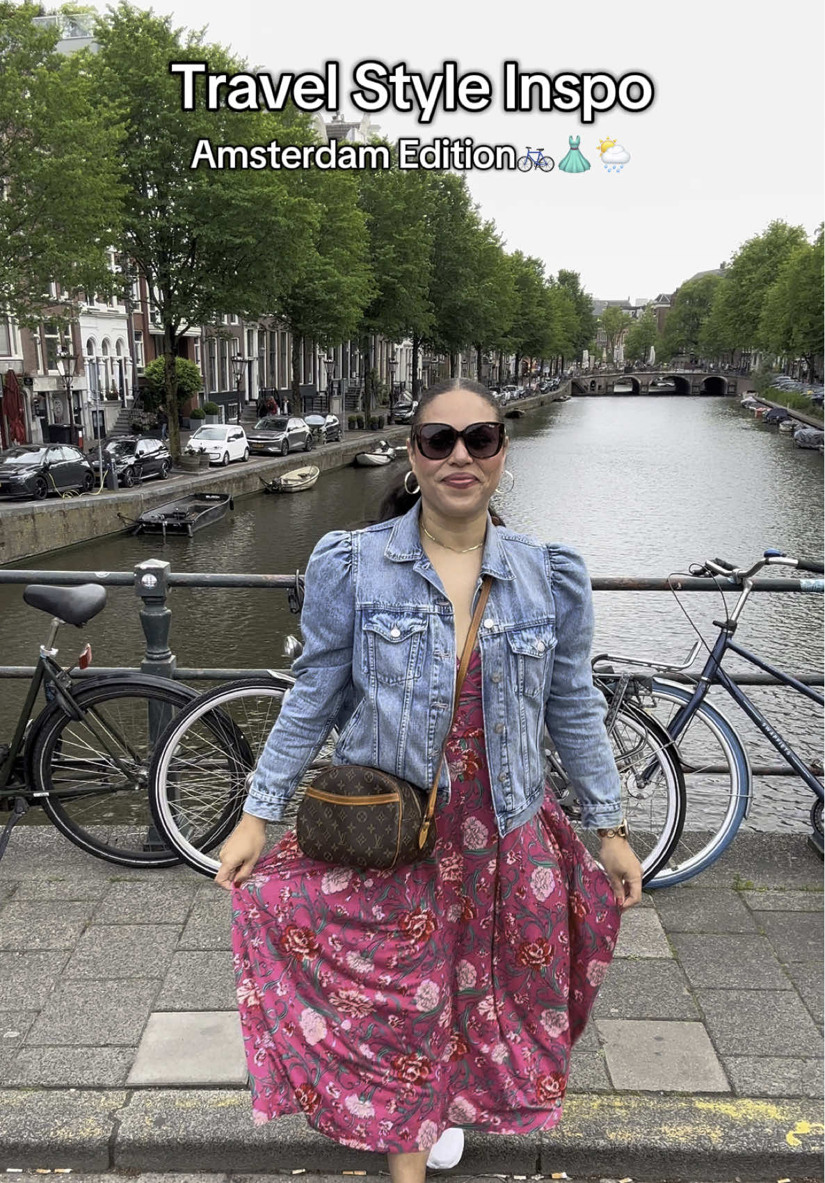 Replying to @red_krist Amsterdam fit check✌🏽🚲🌦️🩷 This dress is perfect for traveling- so comfy, pretty, and has pockets! It was a bit chilly, wet and windy, so I paired it with my favorite puff sleeve jean jacket.  Outfit details are linked in my bio and on my LTK🫶🏽🩷 #travelstyle #amsterdamguide #amsterdamcanals #traveloutfit #summerdress #boden #midsizefashion 