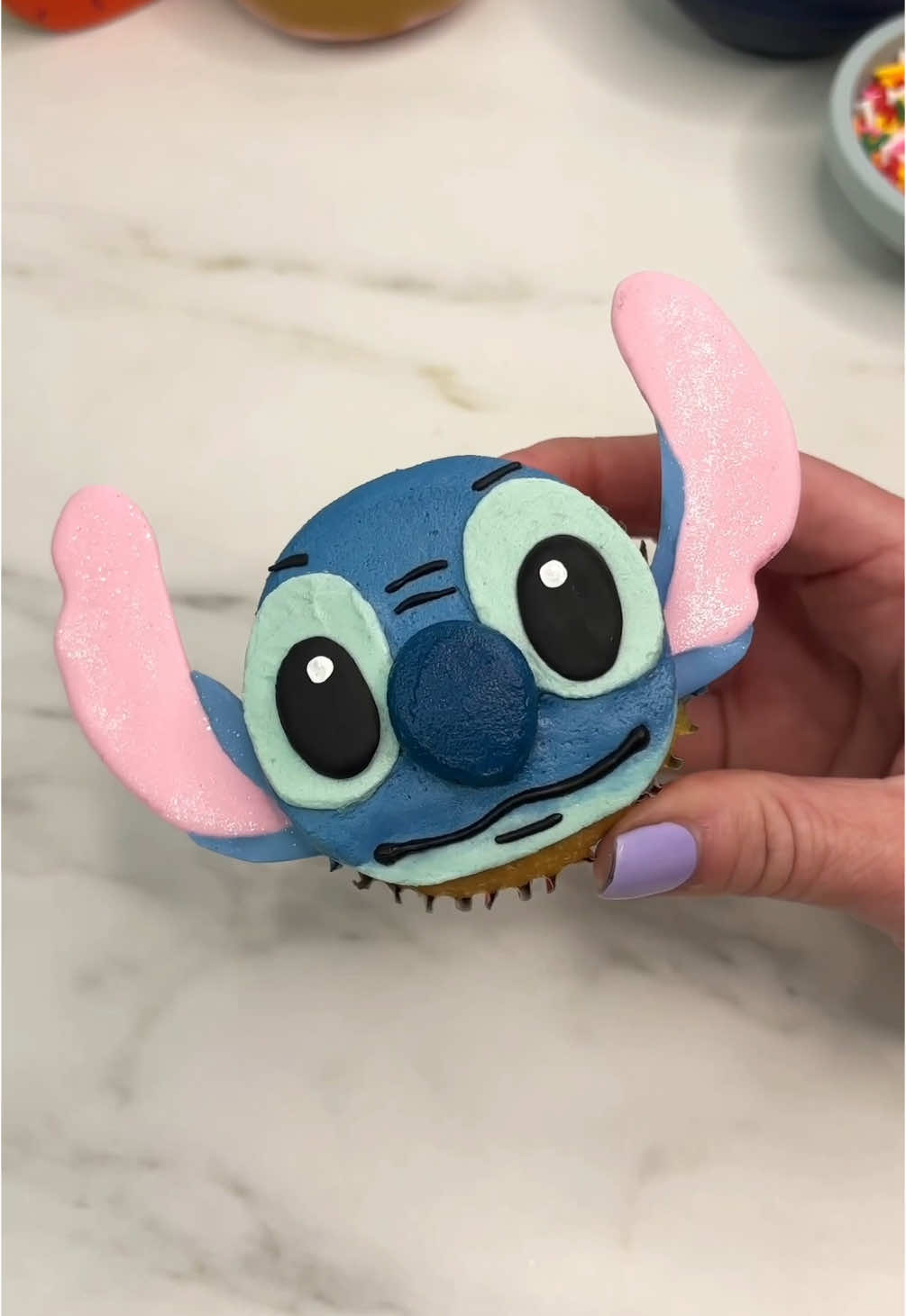 Stitch 💙🩵 Turning a cupcake into Stitch 💙🩵 He is made with two different shades of blue buttercream and I piped his mouth, eyes and ears with candy melts/melting chocolate 🫶🏻💗 #cupcake #cakedecorating #stitch #disney #cakeart #cakedbyrach #stitchmovie #cupcakesforanyoccasion #cutecupcakes 