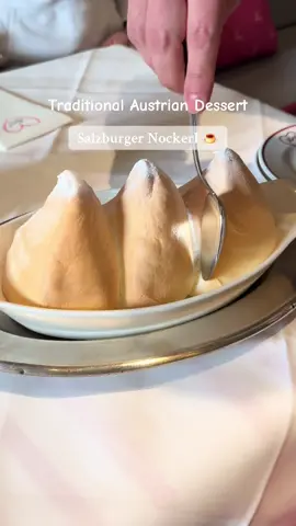 Part 9 | Visiting Salzburg? This should be on your list!  Salzburger Nockerl is a famous, sweet soufflé-like dessert made from whipped egg whites, sugar, and a bit of flour. It's soft, airy, and typically served warm with powdered sugar on top — shaped like three golden peaks, said to represent the three mountains surrounding Salzburg: Mönchsberg, Kapuzinerberg, and Gaisberg. . . . #SalzburgerNockerl #Austria #visitaustria #TasteSalzburg #DessertLovers #Salzburg #AustrianDessert #thingstodo  #FoodieTravel #VisitSalzburg #SalzburgSpecial #travel #FoodFromAustria #explore  #HiddenFoodGems #fyp  #adventure #PlacesToVisit  #creatorsearchinsights #bucketlist #traditional #traditionaldesert #sweet #thingstodoinsalzburg  #citytour #musttry 