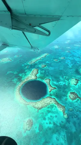 Flying over the blue hole🤩💙 #travel #belize #cayecaulker #bluehole #greatbluehole 