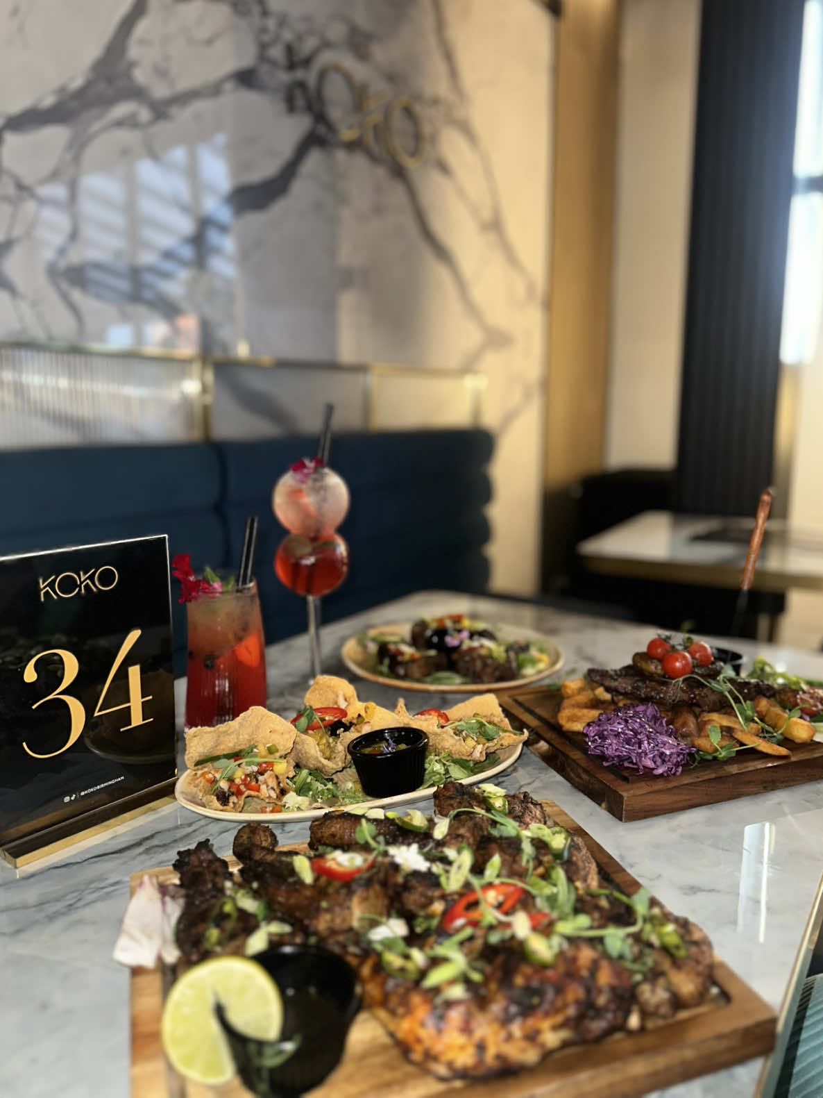 @KOKO RESTAURANT 100 Tyburn Road, B24 8LD📍 Open Monday till Sunday 5pm till 12 at midnight except Friday & Saturday they’re open till 2am!!🤩🤩 Now for the food review:  Drinks: Strawberry Sunset- A vibrant and refreshing start to the meal🤩The Strawberry Sunset is a delightful mix of sweet and tangy, perfect for a warm evening 👌 Island Girl- This tropical concoction will transport you straight to the beach. A smooth and fruity drink that complements the spicier dishes on the menu🔥🧯 Starters: Golden Bags: (Chef's Special) At £10.95, these crispy pastry parcels are a must-try!! Filled with seasoned chicken or prawns, they offer a satisfying crunch and a burst of flavour. The sweet plum sauce adds a lovely contrast👌 Lamb Chops: (Chef's Special) For £9.95, these grilled lamb chops are a steal🙌 Infused with herbs and spices, they are tender and flavorful, and the mint yogurt dip provides a cooling balance🪭 Mains: Mixed Grill Platter: At £29.95, this platter is perfect for sharing😄The combination of lamb chops, jerk chicken, and grilled chicken wings offers a variety of flavours and textures. The refreshing mint sauce ties it all together👌 Sirloin Steak: The 10oz sirloin steak (£32.95) is a carnivore's dream 💭 Marinated in a secret sauce, it's juicy and full of flavour. Served on a bed of signature chunky steak chips and homemade crunchy slaw, this dish is a winner 🏆 ✅ Dessert: Cookie Dough: The freshly made cookie dough (£11.95) is a warm and gooey delight😍 Paired with ice cream, it's the perfect way to end the meal on a sweet note 🎵  Chocolate Fudge Cake: For chocolate lovers, the triple-layer chocolate fudge cake (£9.95) is a must!!! Served with custard, it's rich, decadent, and utterly satisfying😍 Overall: Koko Restaurant offers a diverse menu with something for everyone❣️ The Chef's Specials are particularly noteworthy, and the drinks provide a refreshing complement to the meal. Whether you're sharing a platter or indulging in a steak, Koko promises a memorable dining experience😋🤯 #halal #kokoresturant #koko #birminghamfood #restaurant #FoodTok #missmysterious_xoxo #trendin #foodies #honestreview #mojito #FoodLover #tyburn 
