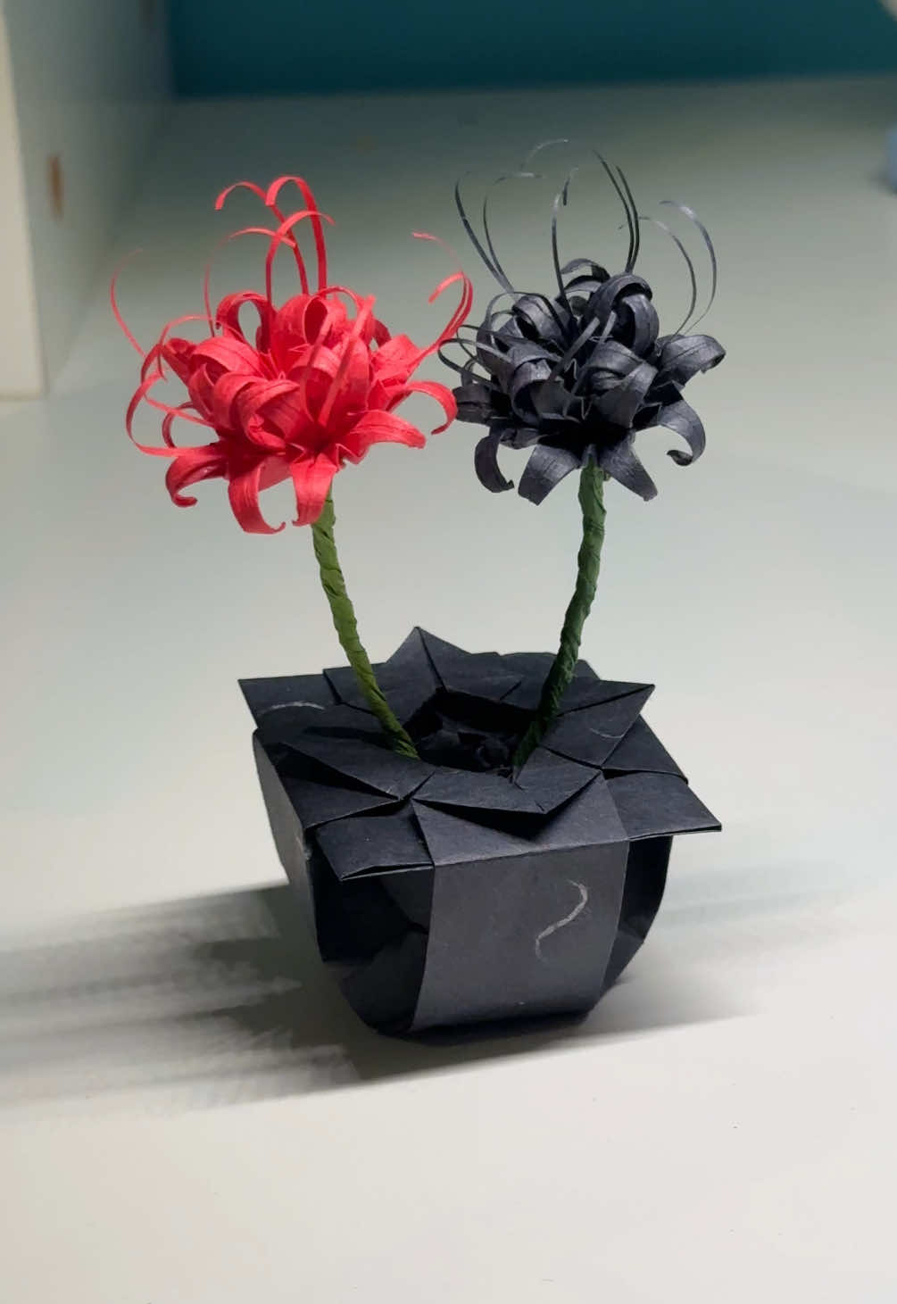 finished the black one, don't they look good together? #origami #redspiderlily #origamiflower #paperflower #papercraft #DIY #tokyoghoul #creatorsearchinsights 