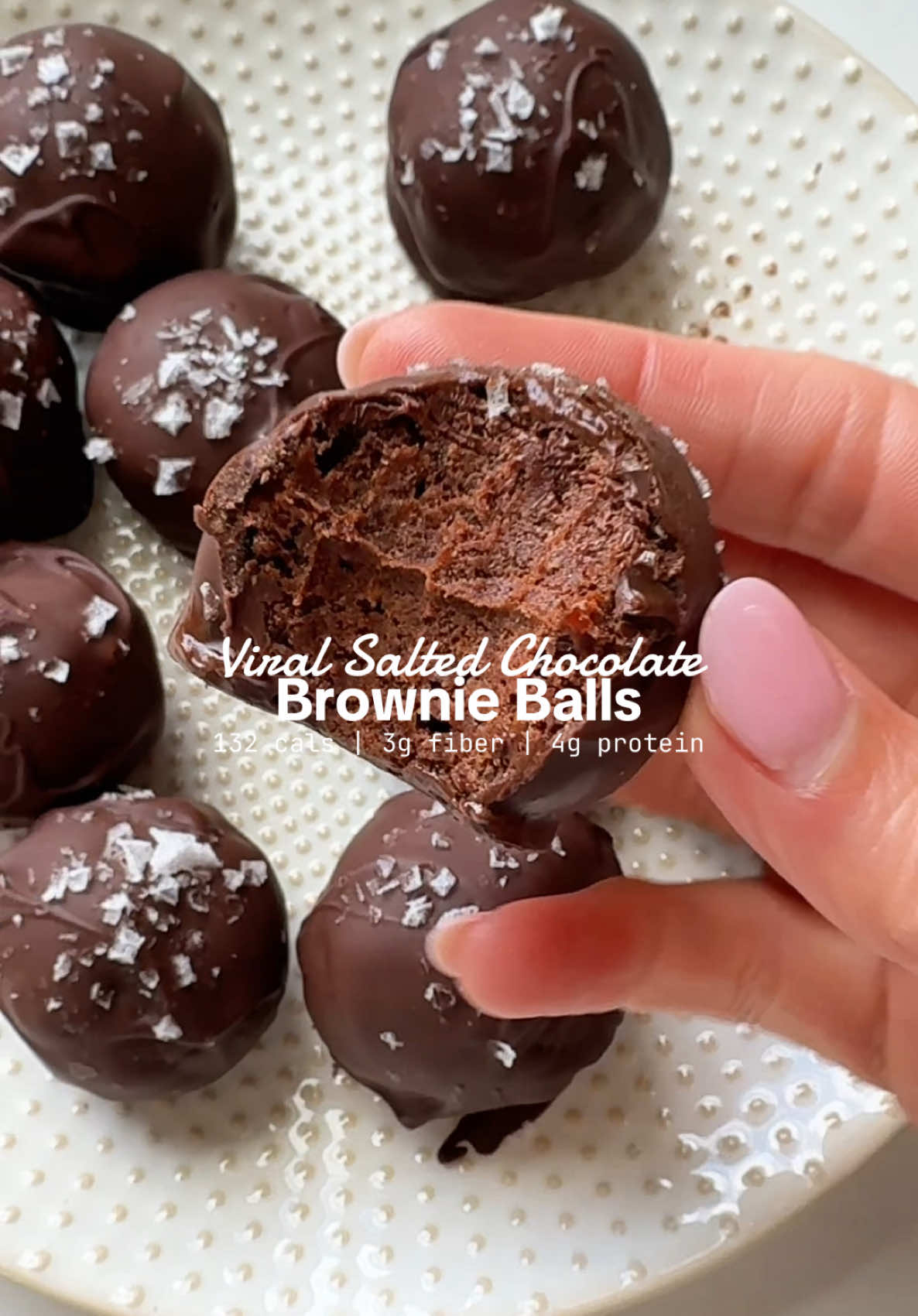 The VIRAL SALTED CHOCOLATE BROWNIE BALLS are pure magic!✨ Naturally sweetened with medjool dates, packed with chocolate protein and coated in melted chocolate with a sprinkle of flaky sea salt… they’re the ultimate no-bake treat. I already want to make another batch. 🍫💪 IB: @elle gibson  Here is how to make them: · 1 ½ cups medjool dates · 3 Tbsp oat flour · 3 Tbsp cacao powder · 1 scoop (25 grams) chocolate protein powder (I used Equip) · 2 Tbsp maple syrup · 2 Tbsp almond or cashew butter  · ½ teaspoon sea salt Chocolate coating:  · ½ cup chocolate chips (I used Lily's) · ½ teaspoon coconut oil  · Flaky sea salt for topping  1️⃣ Add the medjool dates, oat flour, cacao powder, chocolate protein powder, maple syrup, nut butter (almond or cashew) and sea salt to a food processor. Blend until the mixture is well combined and forms a sticky dough. You may need to scrape down the sides once or twice to ensure everything is incorporated. If the mixture seems too dry or isn’t coming together, add 1–2 teaspoons of water and blend again until the dough sticks when pressed. 2️⃣ Use your hands or a small cookie scoop to portion out the dough and roll into even-sized balls. You should get about 12 balls, depending on the size. Place on a parchment lined baking sheet or plate.  3️⃣ Add chocolate chips and coconut oil to a microwave-safe bowl. Microwave in 30-second intervals, stirring between each, until fully melted and smooth (usually about 60–90 seconds total). 4️⃣ Using a fork or dipping tool, dip each ball into the melted chocolate, allowing any excess to drip off. Place the coated balls back on the parchment-lined surface. 5️⃣ Immediately sprinkle each chocolate-coated ball with a pinch of flaky sea salt before the chocolate sets. 6️⃣ Place the finished balls in the fridge or freezer for 10–15 minutes to allow the chocolate to harden. Once set, store in an airtight container in the refrigerator for up to 1 week or in the freezer for up to 3 months. Macros (per 1 ball): 132 cals | 3g fat | 25g carbs | 3g fiber | 4g protein #HealthySnacks #proteinballs #nobaketreats #highproteindiet #sweettreat 