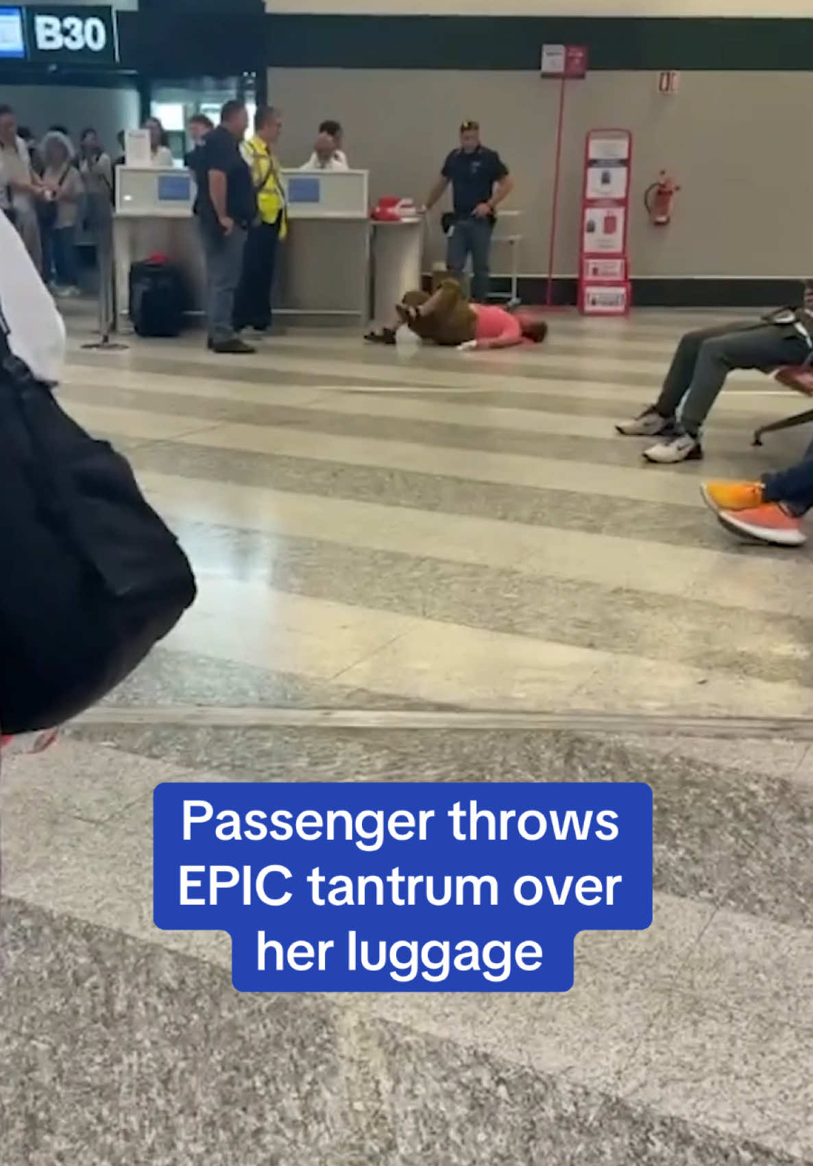 A passenger threw an embarrassing tantrum rolling around the ground - because her hand luggage was too heavy to take onboard. The Chinese tourist had reached the boarding gate when staff checked her carry-on suitcase at the airport. They told her to pay extra or throw away some of the contents, sparking an allmighty meltdown in front of astonished travellers. Read more at DailyMail.com  🎥 Viral Press #milan #chinese #airport #luggage #suitcase #meltdown #tantrum 