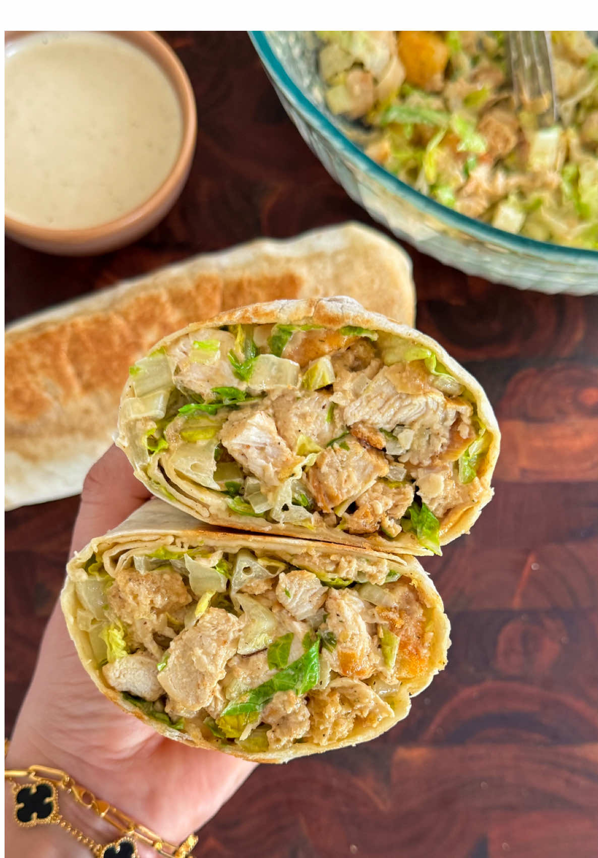 Chicken Caesar Wrap  Who said salads have to be boring? Meet your new lunch obsession, this Chicken Caesar Wrap is made with juicy pan-seared chicken, crisp lettuce, and dreamy homemade Caesar dressing, all wrapped in a tortilla then toasted to golden. It’s the wrap you didn’t know you needed 😋🌯  #ChickenCaesarWrap #WrapGoals #HomemadeGoodness #LunchInspo #EasyMeals #FoodieFavorites #CaesarSaladGlowUp #ToastyWraps #RecipeReel ——Chicken Ingredients—— 2 chicken breasts (pound until even) 1 teaspoon lemon pepper  1 teaspoon garlic powder  1 teaspoon onion powder  1 teaspoon paprika  1/2 teaspoon salt 1/4 teaspoon black pepper  3 tablespoons of olive oil  ——Caesar Dressing—— 1 cup mayonnaise  2 tablespoons Dijon mustard  2 tablespoons Worcestershire sauce 2 cloves garlic (minced or grated)  The juice of 1 lemon  1/2 cup extra virgin olive oil  1/2 cup grated Parmesan cheese  1/2 teaspoon salt  1/2 teaspoon black pepper  ——For the salad—— 2 hearts of romaine  1 cup of Parmesan cheese shavings Croutons (as much as you want) 3-4 large tortillas  1. Pound the chicken breasts until they are an even thickness for quick and even cooking. In a small bowl mix together 1 tsp lemon pepper. 1 tsp garlic powder, 1 tsp onion powder, 1 tsp paprika, ½ tsp salt, ¼ tsp black pepper and Season both sides of the chicken.  2. Heat 3 tbsp olive oil in a skillet over medium heat. Add the chicken and sear for 5–6 minutes per side, or until golden and fully cooked (internal temp: 165°F). Remove from heat and let rest before cutting into pieces.  3. Make the Caesar Dressing, In a large bowl, whisk together mayo, Dijon mustard, Worcestershire sauce, minced garlic, Juice of 1 lemon, extra virgin olive oil, grated Parmesan, salt, black pepper and Whisk until well combined (Reserve some for dipping).  4. Chop the lettuce and the cooked chicken, add it to the dressing. Add in the Parmesan shavings and croutons, toss everything together until well coated in the dressing.  5. Warm your tortillas slightly to make them pliable. Add a generous amount of the Caesar salad in the middle of the tortilla.  6. Fold in the sides of the tortilla and roll tightly into a wrap. Toast the wrap for 1-2 minutes per side, until golden. 