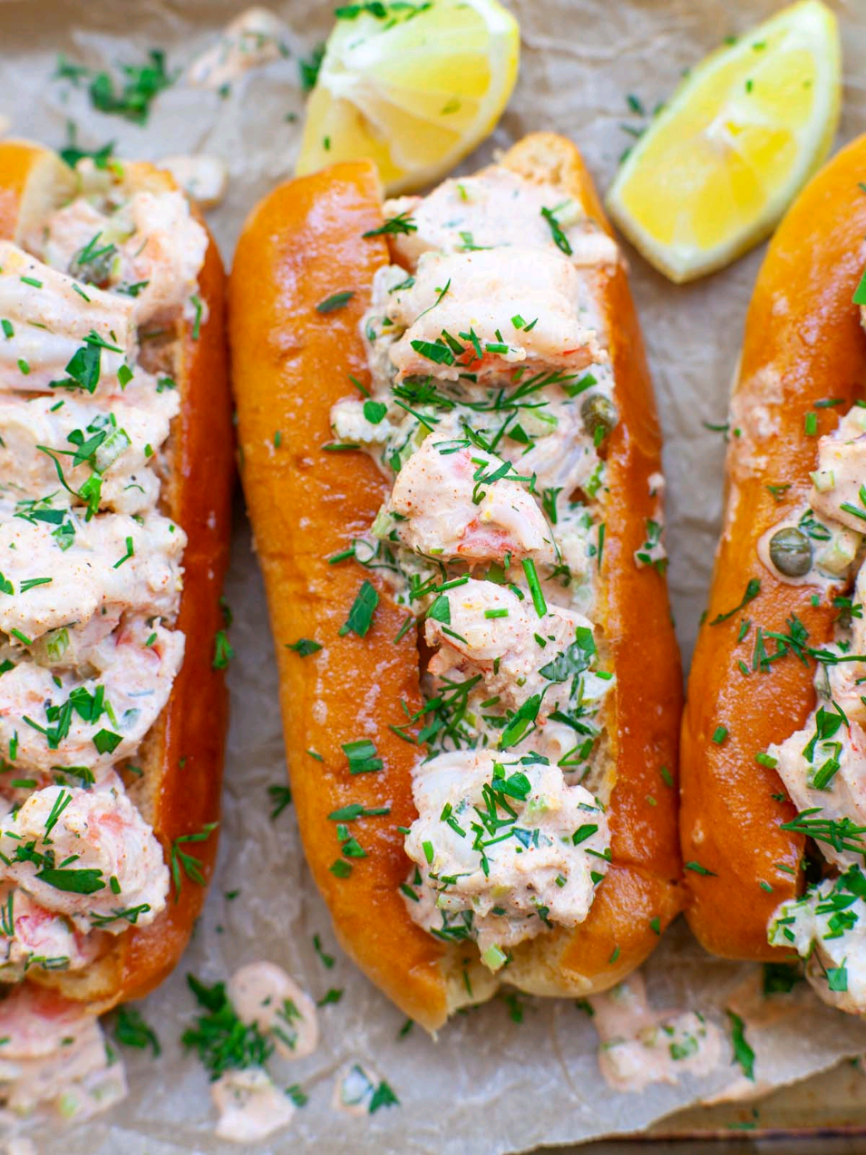 My favorite shrimp rolls are perfect for summer lunches and dinners! Made with sweet, jumbo shrimp coated in a creamy, lemony, garlicky sauce, served on toasted brioche rolls. Super easy to make and SO delicious!! Get all the recipe details on my website! https://tatyanaseverydayfood.com/best-shrimp-rolls/  Ingredients: 1 1/2 lbs jumbo shrimp 6 brioche buns 2 tbsp butter, for toasting bread 2 large lemons, for serving For Creamy Dressing: 3 sticks celery 2 green onions 2 tbsp fresh chopped parsley 2 tbsp fresh chopped chives 2 tbsp fresh chopped dill 2 tbsp capers zest from 1 lemon 2 to 3 tbsp fresh lemon juice 3 large garlic cloves 1 tbsp red wine vinegar 1 1/2 tbsp Dijon mustard 1/2 cup mayonnaise 1 1/2 tsp sea salt 1 tsp dried onion powder 1 tsp paprika ground black pepper  #whatsfordinner #dinneridea #shrimp #rolls #shrimproll #homecooking #Summer #summerrecipes #EasyRecipe #quickmeals #Foodie #delicious #foodnetwork #garlic #bonappetit #tatyanaseverydayfood 