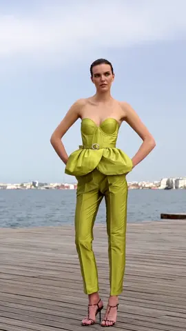 Bold structure meets seaside sophistication. This lime-green tailored set features a sculpted strapless corset with a petal-like peplum, paired with sleek high-waisted pants. #elegant #fashionblogers #style #outfit #couture #mischalis #atelier