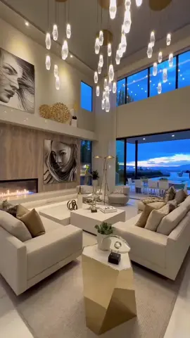 This Living Room Feels Like a Movie Set 🎬 Creamy sofas, a sculptural gold side table, and a cascade of glass pendant lights—this living room glows with warmth and elegance. The fireplace crackles in the background, inviting you to sink in and stay awhile. DM me to design a space that feels like home. Credit to Lyfairs_pendant_lights (Pin) #ModernHomeVibes #InteriorDesignTok #LuxuryLivingRoom #KitchenInspo #HomeDecorGoals #DreamHomeDesign #MoodyAesthetic #ArchitecturalDetails #HouseGoals2025 #ElegantInteriors #Etbox 