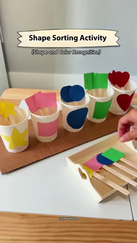 Want a fun way to teach shapes? Try this DIY shape sorting activity using cups, colored papers and popsicle sticks. Give it a go and see how much they'll enjoy it! #montessoriactivities #diyactivitiesforkids #learningthroughplay #shapesorting #ToddlerActivities #PreschoolActivities #kindergartenactivities #shapeactivities 