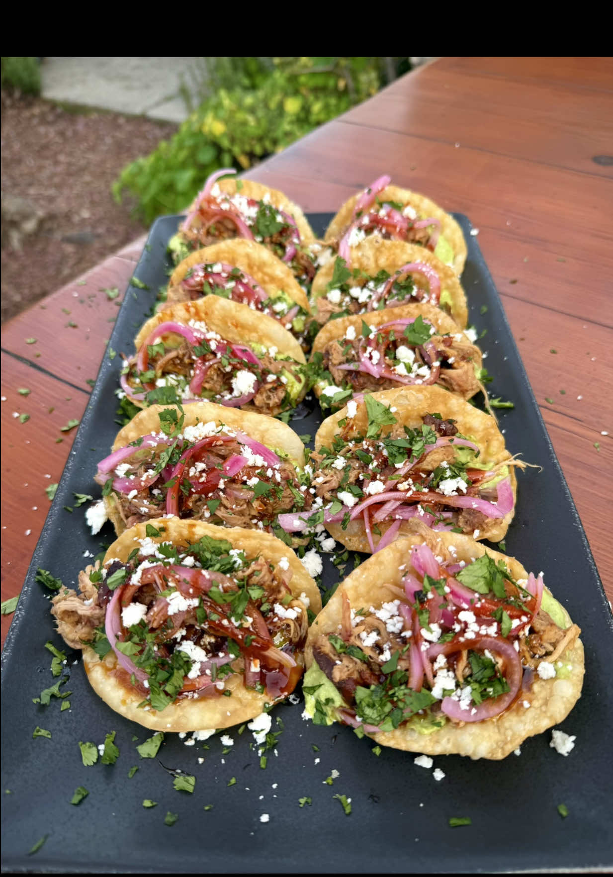 🔥Mini Wonton Pulled Pork Tacos🔥 With Hot Honey, Pickled Red Onions, Hot Sauce, Cojita Cheese, and Avocado Tomatillo Salsa.   🔥🌮 Here’s the full recipe 👇 Ingredients: Pork: * 1 bone-in pork butt * FYR Hot Sauce (binder) * Favorite BBQ rub * Melinda’s Hot Honey * FYR RED Hot Sauce Pickled Red Onions: * 1 large red onion, sliced * 4–5 garlic cloves * 1 tbsp black peppercorns * 1½ cups hot water * ½ cup white wine vinegar * 1 tbsp sugar * 1 tsp salt Avocado Tomatillo Salsa: * 3 avocados * 4 boiled tomatillos * 3 limes, juiced * ½ white onion * 1 jalapeño * ½ cup cilantro * 5 garlic cloves * 2 tbsp olive oil * Salt & pepper Tacos: * Wonton wrappers * Canola oil (for frying) * Cotija cheese * Chopped cilantro & lime wedges (garnish) ⸻ Instructions 1. Prep the Pork: Score fat cap, season with FYR Hot Sauce and rub. Refrigerate overnight. 2. Smoke: 250°F for 8–10 hours until probe tender (200–207°F). Wrap at 175°F if desired. Rest 2–3 hours. 3. Pickled Onions: Combine all ingredients in a jar. Shake and let sit. 4. Salsa: Blend all salsa ingredients until smooth. 5. Wonton Shells: Cut wrappers into 4” rounds. Fry in taco molds at 350°F for ~1 min until golden. 6. Assemble: Spread salsa on shell, add pulled pork, drizzle hot honey + FYR RED, top with onions & Cotija. Garnish with cilantro and lime. Pair with: A bold California Pinot Noir or Zinfandel 🍷 #gamechangertacos #wontontacos #pulledporktacos #bbqlife #hotandsweet #smokenvine #tacotuesday #kamadojoe #teamred #crunchytacos #avocadosalsa #bbqnation #reelsrecipe #fyr #wonton #wontons #bbq #wontontaco #minitacos #happyhour #appitizers #delicious #yum #bitesize #food  @Kamado Joe @Melinda's Hot Sauce @blazingstarbbq @blazingstarshop @Jealous Devil @AMF @FYRSTARTER @Derek Wolf @SPICEOLOGY @waringproducts @blendtec @MEATER @Swift Meats @FOOD 🍟 @Food Network @Foodie @Gordon Ramsay @HexClad @foodandwine @Foodies @Foodporn 