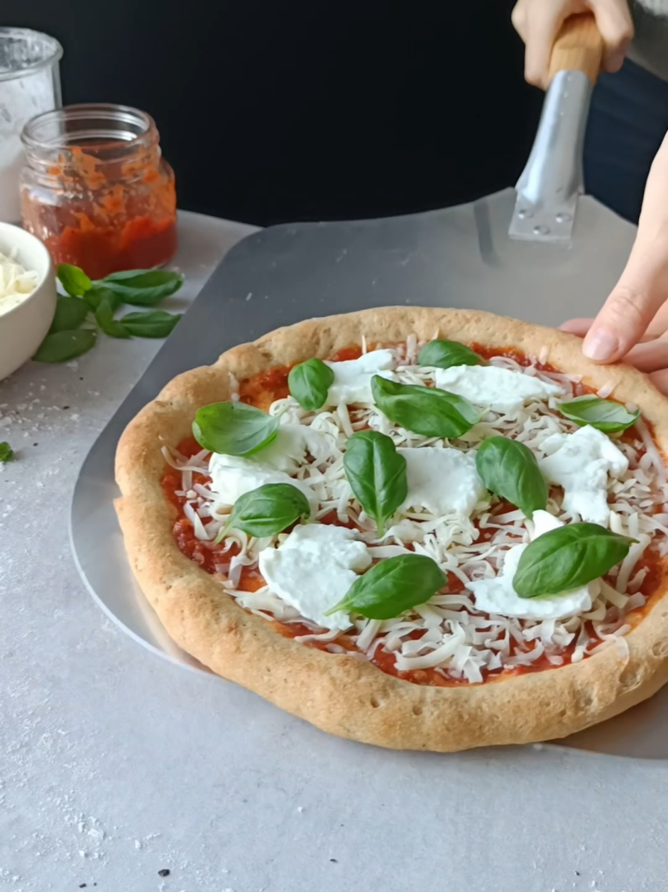 Weekend means pizza 🍕  This GF sourdough pizza crust is made with a variety of whole grain flours for extra nutrition and flavour. It bakes up crisp and chewy with a beautifully open crumb in the edge ❤️ Levain: 30 g active sourdough starter 60 g water 45 g brown rice flour* 15 g gf oat flour* Pizza dough (makes 3 crusts): 300 g water 16 g psyllium husk powder 150 g levain 60 g quinoa flour* 40 g oat flour* 40 g brown rice flour* 40 g light buckwheat flour* 60 g potato starch 6 g sea salt *I used flours from @detglutenfrieverksted 👌🏻  Build the levain: 1. Weigh 30 grams of active starter in a clean jar, then add the water and whisk together. 2. Add the flours and ferment the levain for 6-8 hours, or until it's bubbling and it has risen to a peak, before mixing it into the dough. Make the pizza dough: 1. In a large mixing bowl, add the water and psyllium husk powder. Whisk vigorously until it’s fully incorporated and starts to thicken. Set aside for 10 min. 2. Add the mature levain to the psyllium mixture and mix until everything is well incorporated. Add the flours, potato starch and sea salt and knead for 5-10 min until the dough is smooth. The dough will be a little sticky, it should be like that. 3. Transfer the dough to a lightly oiled surface and divide it into three equal pieces, about 236 g each. Shape each piece into a ball. 4. Place the dough balls in separate greased containers, cover and either proof in a warm place for 4-6 hours, or proof in a warm place for 1 hour before placing them in the refrigerator for 12-48 hours. If proofing in the fridge, take the dough out 1-2 hours before baking, so it’s easier to shape. 5. Place a baking steel, pizza stone or baking sheet on the middle oven rack and preheat the oven to 250°C. Lightly grease a sheet of baking paper with olive oil and place a proofed pizza dough ball on the sheet. With lightly oiled hands, gently press and stretch the dough out into a 23 cm circle. 6. Transfer the pizza (on the baking paper) to the preheated baking steel, pizza stone or baking sheet and bake for 10-12 minutes.  7. Remove from the oven and top the crust with your favourite pizza toppings, and bake for about 6-8 more minutes. Remove from the oven, slice and serve immediately. Enjoy! #glutenfree #sourdough #glutenfreerecipes #sourdoughpizza 