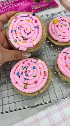 Make these deliciously thick, soft, chewy cake batter sugar cookies using simple ingredients and fancy sprinkles Rainbow Baking Confetti. (available at the walmart baking aisle) These sprinkles are the best for baking because they do not bleed, stay crunchy and taste amazing. These cookies are a crowd favorite and so easy to make! In a bowl, cream 1 cup of softened butter, 1 cup sugar and 1/4 cup of brown sugar Mix in 1 egg, 1 tsp vanilla, 1 tsp cake batter extract, 2 1/2 cups flour, 1 tsp baking soda and a pinch of salt just until it looks like cookie dough. Do not over mix. Fold in Fancy Sprinkles Rainbow Baking Confetti. Use a large scoop to scoop dough and roll in to a ball. Bake at 350 F for 8 minutes for a soft chewy center or 10 minutes for a firmer cookie. Frost with American buttercream and garnish with additional Fancy Sprinkles Rainbow Baking Confetti. #cookies #cookierecipe #cakebatter #birthdaycakecookies #cookierecipe #sugarcookies #crumblcookies 