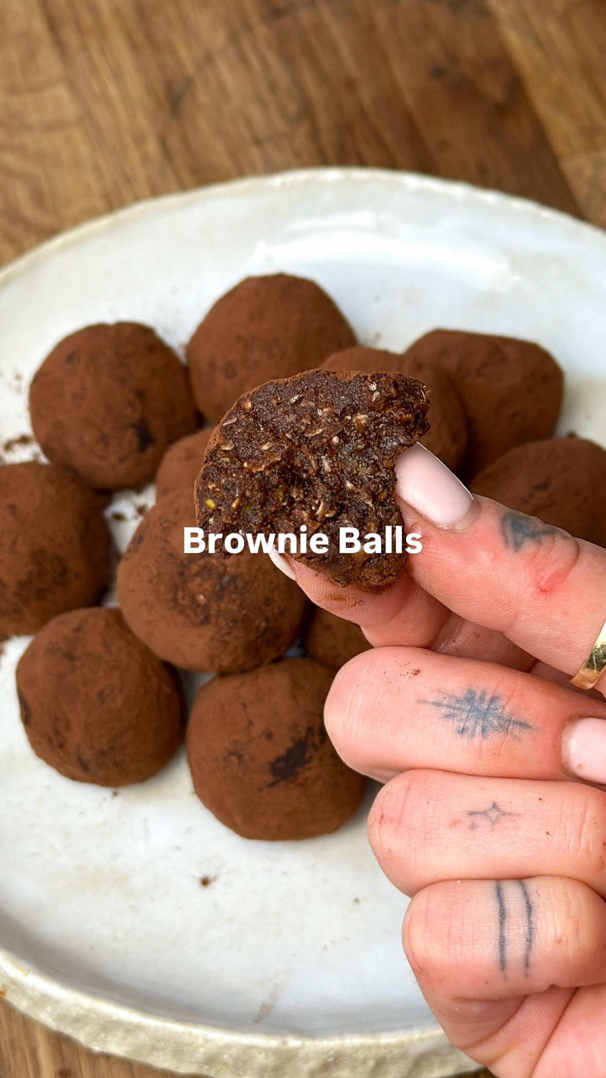 BROWNIE BALLS 🍫🍰 Idk the science behind these but they legit taste like brownie batter and the texture!?!? Insane. Soft and almost chewy, teeth mark MADNESS!!!  Ingredients (made 15):  2 tbsp chia seeds  2 tbsp maca powder  1/3 cup oats  4 dates, soaked in hot water for 10mins  2 tbsp cocoa powder  2 tbsp peanut butter  2 tbsp cashews  2 tbsp pistachios  1 tbsp honey  1/2 tsp vanilla  Salt  I honestly just used whatever and measured with my heart!  Keep the date water on hand to add to the mixture if it’s too dry  Cocoa for dusting  #sweettreat #groceryban #healthytreats #healthyrecipes #brownieballs #blissballs 