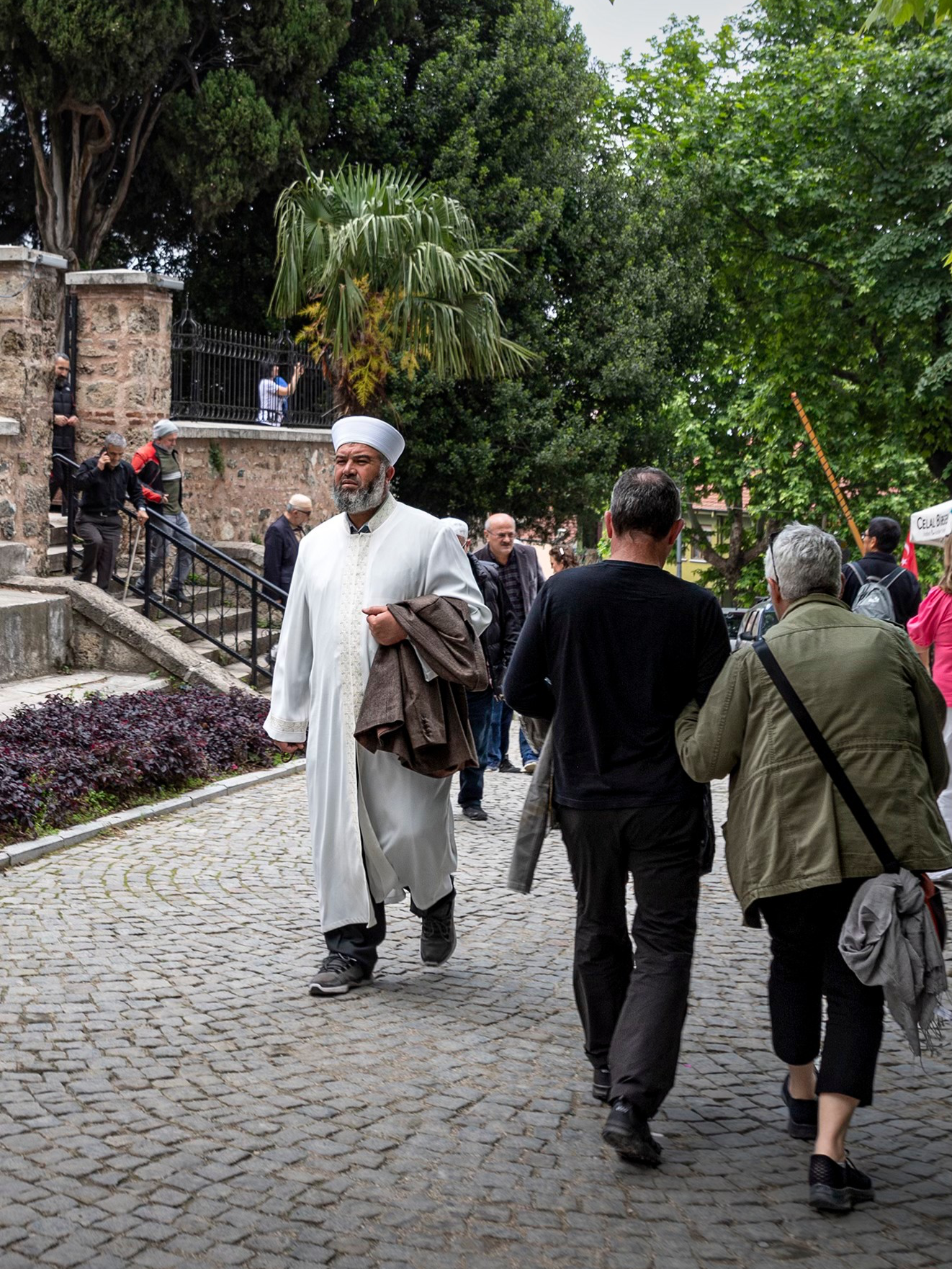 In Bursa, Turkey, funeral ceremonies follow Turkish and Islamic customs, emphasizing prompt burial, religious readings, and expressions of grief. At a funeral ceremony in Bursa, Turkey, people pray outside the mosque because the main prayer for the deceased is performed in an open space, usually in front of the mosque, after the ritual bath and before the burial. This prayer, called 