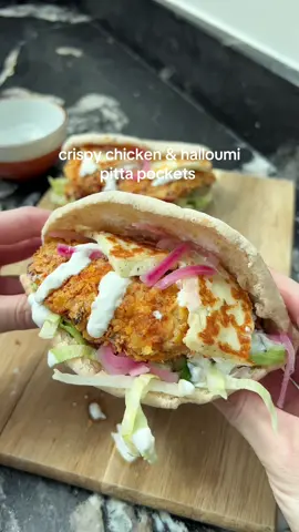 Crispy Chicken & Halloumi Pitta Pockets😍 These were BANGIN. Toasted pitta bread stuffed with crispy cornflake chicken, pan fried golden halloumi, salad and a garlicky yoghurt sauce. Easy, high protein and perfect for a summer dinner 🫶🏼 ‼️Get 50% off my new cookbook ‘20 Minute Low-Cal Kitchen Bangers’ when you pre-order on Waterstones using the code ‘LowCal25’ at checkout 🎉🎉 link is in my bio 🫶🏼 (available until the end of August)  Ingredients (serves 2): 1 tsp garlic granules  1 tsp dried oregano  1 tsp smoked paprika  Salt  Pepper  60g fat free thick greek yoghurt  1 tbsp lemon juice 1-2 tbsp semi-skimmed milk  2 x 125g chicken breasts flattened  35g cornflakes crushed  1 tbsp plain flour  40g reduced fat halloumi sliced  2 pitta breads (I used Tesco) 2 handfuls of shredded lettuce  A few spoonfuls of pickled red onion 2 slices of tomato  40g diced cucumber  Garlic yoghurt sauce: (can use garlic mayo or peri) 60g fat free greek yoghurt  ½ tsp chopped garlic  Pinch of salt  1 tbsp lemon juice  💕Mix the seasonings together. 💕Use 2 tsp to season the chicken breasts all over. 💕Add the yoghurt, lemon juice and milk to a bowl. Mix well, before adding in the chicken. Leave to marinate for 30 minutes. 💕Toss together the remaining seasoning, crushed cornflakes and plain flour. Dip the chicken into the crushed cornflakes mix, pushing into adhere. Air fry at 190 degrees celsius for 16 minutes turning part way through. 💕Meanwhile, make the garlic yoghurt sauce with the ingredients listed, and set to one side.  💕Pan fry the halloumi for a couple of minutes each side until golden. 💕Toast the pitta breads according to packet instructions.  💕 Fill the pitta with the lettuce, tomato, cucumber, some pickled onions, the chicken, garlic sauce, halloumi and more pickled onions.  Calories per pitta: 540 l Protein: 48.3g l Fat: 10.35g l Carbs: 62g • • ____________ #crispychicken #halloumi  #dinnerrecipes #mealideas  #highproteinmeals #EasyRecipes   
