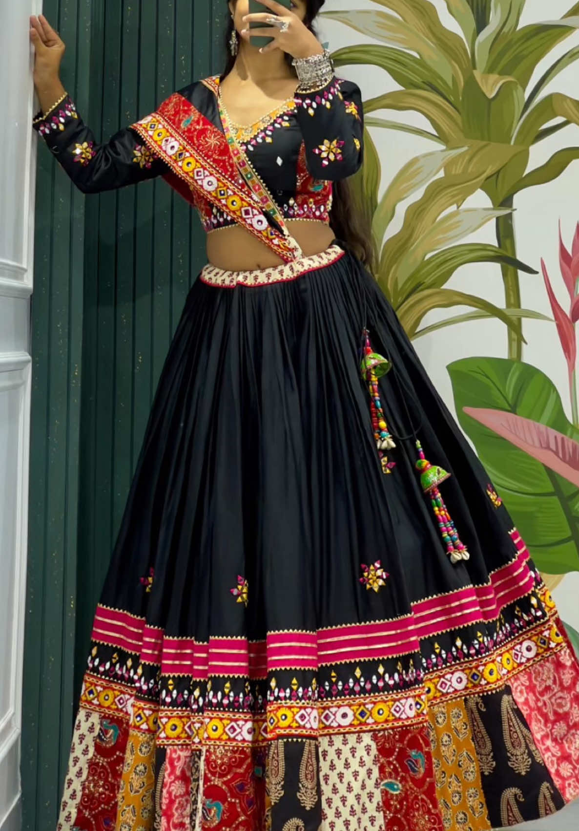 ✨ Navratri 2K25 Look Black ✨ 🌸 Outfit Description: Step into the festive vibes of Navratri 2025 with this stunning traditional Chaniya Choli, blending vibrant embroidery and mirror work for the perfect garba glam! Choli (Blouse): Contrasting black design with intricate mirror work and multicolor embroidery, featuring one full sleeve and one sleeveless pattern for a trendy twist. Lehenga (Skirt): Black base with colorful thread embroidery and mirror work motifs scattered throughout. Hemline is adorned with patchwork borders in traditional prints and vibrant shades like mustard, red, maroon, and black, giving a rich ethnic touch. Embellished with mirror tassels and handmade latkan for that perfect twirl during garba nights. Dupatta: Soft magenta dupatta with traditional kutchi border embroidery and mirror detailing, beautifully complementing the blouse. Fabric: Gaji Silk & Cotton blend with mirror work and embroidered patchwork borders. Comfortable and flowy for long hours of dancing. Size Reference: Free size (Fits up to 42”) Adjustable drawstring waist Full length lehenga 40-42 inches, 8 plus meter  #trending #foryoupage #chaniyacholi #gujju #WomenOfTikTok #fyp 