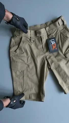 UATAC Shorts Lite Flexible Lite UATAC Tactical Shorts are specially designed for military use, featuring a universal cut suitable for various conditions — training, shooting range, work, or casual wear. The fabric is made of 58% cotton, 39% polyester and 3% elastan, which makes it soft to the touch and resistant to tearing and damage. The Ripstop weave prevents the shorts from ripping even under heavy loads. Large cargo pockets with Velcro. Equipped with an additional compartment for oversized items and a carabiner. A side zipper on the cargo pocket allows easy access while seated. A special convenient phone pocket is located on the right side. Two front pockets are designed for a knife or flashlight.  The waistband is elastic and stretchable. The shorts are suitable for use with a belt up to 6 cm wide. Convenient Velcro fasteners on the leg cuffs ensure a secure fit.  Fabric: 58% cotton, 39% polyester, 3% elastan. Ripstop weave Elastic 