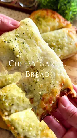 “Cheesy Garlic Bread crispy, buttery, garlicky, and oozing with melty cheese,perfect as a side or snack!” Comment “Garlic Bread” and you’ll the recipe!  Ingredients: * 1 loaf French bread or Italian bread (cut in half lengthwise) * 1/2 cup (1 stick) unsalted butter, softened * 3–4 cloves garlic, minced * 2 tbsp fresh parsley, chopped (or 1 tsp dried parsley) * Salt and pepper to taste  * 1/2 tsp Italian seasoning  * 1/2 tsp dried onion  * 1/2 tsp garlic powder  * 1/4 tsp red chili flakes (optional for a kick) * 1 ½ cups shredded mozzarella cheese * Shredded Swiss and Gruyère cheese as needed  * 1/4 cup grated Parmesan cheese * Olive oil (optional, for brushing crust) #garlic #bread #cheese  #creatorsearchinsights #fyp #fypシ #foryou #foryoupage 