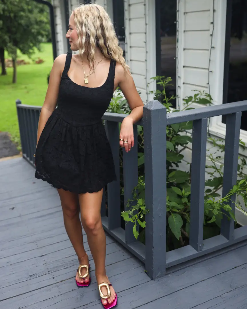She’s giving chic with a side of sass. This black lace mini from Show Me Your Mumu + those metallic pink flip flops? Instant outfit upgrade. ✨ We’re calling it: the little black dress just got a whole new attitude. 🖤 Shop the full look in-store & online 📍 Tulsa + Stillwater #ShowMeYourMumu #JcoleShoes #OOTD #SummerStyle #MetallicHeels #LBDmoment #BoutiqueStyle #WhatToWear #StyleInspo #StatementShoes #ShopSmallOK #TulsaStyle
