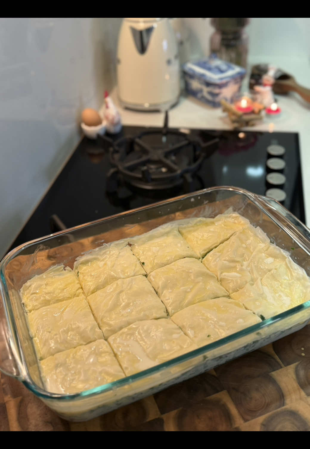 Replying to @Engey 🏡Cheese Börek – Layered Filo Pastry with Mixed Cheeses and Parsley My Way 🍽️🤍.  بوراك بالجبنة – رقاقات محشوة بخليط أجبان وبقدونس على طريقتي 💫.  Ingredients 💌: 250 g butter, melted (you can use less if preferred) 200 g mozzarella cheese (≈ 2 cups, shredded) 100 g cheddar + parmesan cheese (combined ≈ 1 cup, shredded) 280 g halloumi cheese, grated (≈ 2½ cups) 2 cups finely chopped parsley 375 g filo pastry = 20 sheets 2 cups of cold milk  1 egg + pinch of salt Method 🖊️: Make the filling 🧀: 1:Combine all cheeses with the parsley. Mix well . 2:Layer the base Trim the filo sheets to fit your baking tray. Lay down 10 sheets, brushing each one lightly with melted butter.🧈  3:Add the filling,Spread the cheese mixture evenly over the layered filo. 4:Layer the top, Cover the filling with the remaining 10 butter-brushed sheets. 5:Whisk the milk, egg and pinch of salt until smooth, then pour evenly over the pastry.(Soaking it in milk makes everything come together just right, soft on the inside, perfectly crisp on the outside ✨).Cut the börek in the tray into squares . 6:Cover the tray and let it stand 30 minutes so the pastry absorbs the milk. 7:Bake on the middle rack of a pre-heated 180 °C (356 °F) oven (top-and-bottom heat) for 40 min, until deep golden. 8: Cool & serve,Let the börek cool about (40- 50 min) so the cheese sets, then lift out neat pieces. Serve warm with cucumber, tomato, and a cup of tea. Enjoy!❤️.  المكونات:🪶 ٢٥٠ غرام زبدة مذوبة (ممكن استخدام كمية أقل حسب الرغبة) ٢٠٠ غرام جبنة موزاريلا (كوبين) ١٠٠ غرام جبنة تشدر مع بارميزان( كوب واحد) ٢٨٠ غرام جبنة حلوم مبشورة  ٢ كوب بقدونس مفروم ناعم ٣٧٥ غرام رقاقات(٢٠ ورقة)  ٢ كوب حليب + ١ بيض + رشة ملح.  للتوضيح ١ 💌: ليش منسقي البوراك بالحليب؟ لحتى تمسك الطبقات ببعضها، وتطلع البوراك طرية من جوا ومقرمشة من برا. للتوضيح ٢ 💌: ليه منتركها ترتاح نص ساعة؟ لحتى تشرب العجينة خليط الحليب، وتتماسك الطبقات قبل الخَبز، وبتطلع النتيجة أطيب وأسهل بالتقطيع.  للتوضيح ٣ 💌:ليش منترك الصينية تبرد قبل التقديم؟ لأنو إذا قدمنا البوراك وهي سخنة كتير، الجبنة بتكون سائلة والطبقات بتتفكك. منترك صينية البوراك تبرد حوالي ٤٠ /٥٠ دقيقة بعد الخبز، لحتى تتماسك الجبنة والطبقات، ويصير التقطيع سهل من دون ما تفتّت.