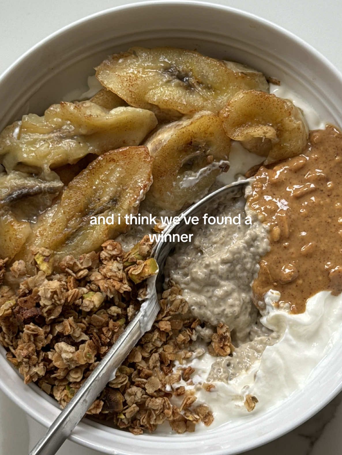 no no when i tell you i’m still thinking about this one. (for 2x servings coffee chia pudding) you’ll need: - 50ml any milk - 2 heaped tbsp coconut yogurt  - 1tbsp honey - 1 shot espresso (or instant coffee, dissolved!) - 2tbsp chia seeds  for the rest: - 1 banana - small knob butter - a dash of cinnamon  - 2tbsp granola (recipe on my brekkie ideas playlist!) - 1tbsp peanut butter  method: 1. begin by combining milk, yogurt, espresso, honey and chia seeds in a small bowl and mix thoroughly. 2. place in the fridge for at least 30 minutes or longer if desired!  3. meanwhile, slice or cut lengthways a whole banana. 4. melt a small knob of butter in a pan and add a dash of cinnamon to it whilst melting. 5. spread the butter over the pan and place the banana carefully on it. 6. fry for a few minutes on each side or until caramelised and golden brown. 7. meanwhile, prepare yogurt of choice in a bowl and make a well in the centre. 8. place the chia pudding in the well and top with the caramelised banana. 9. add whatever granola you like (I’m using my pistachio granola!) in the corner, followed by a generous tbsp of peanut butter. this deserves a BIG ‘enjoy’ for you guys bc omg it’s my fave.🥹☕️ #yogurtbowl #yogurt #breakfast #breakfastideas 