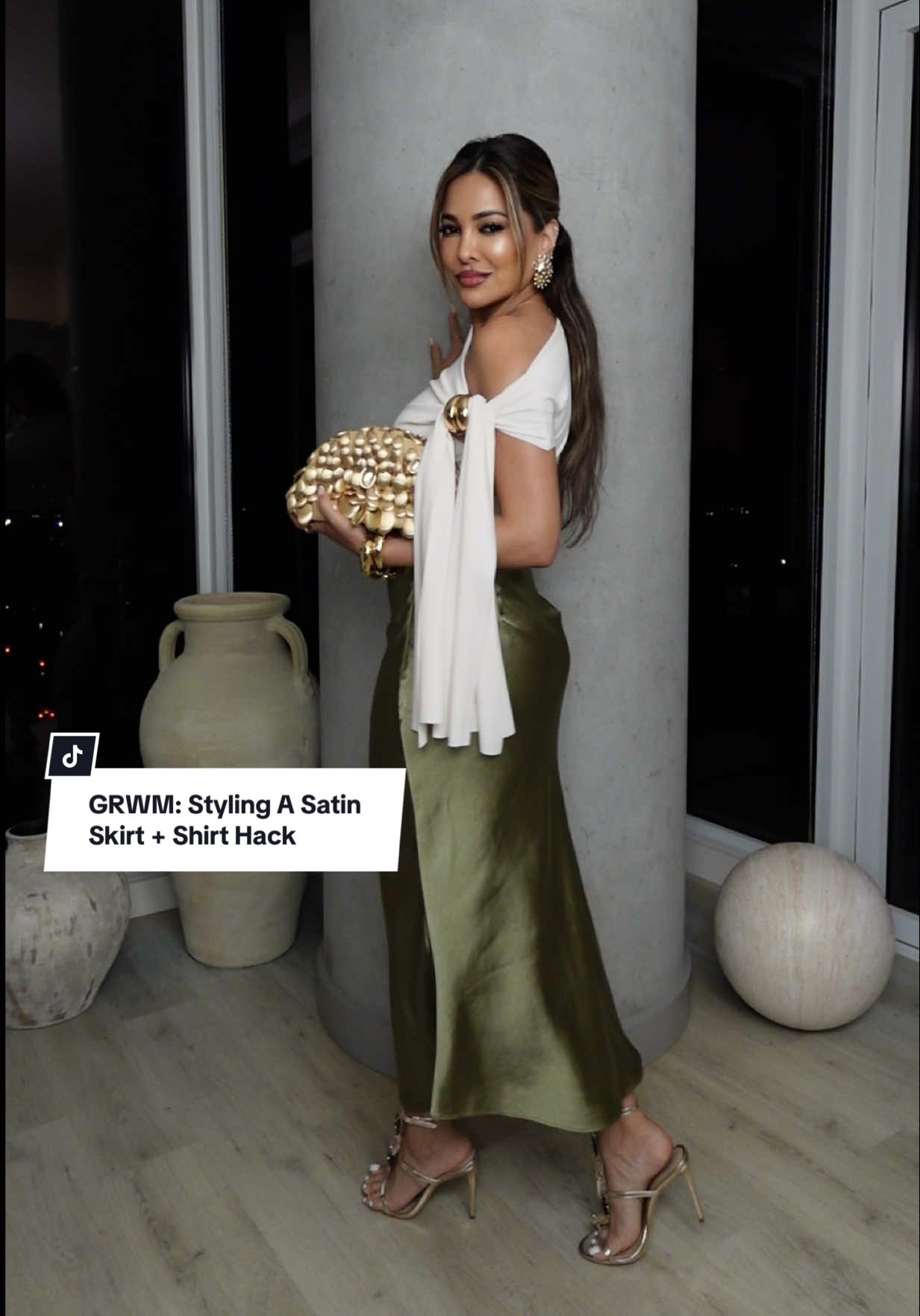 GRWM: Styling A Satin Skirt + Shirt Hack✨ #fyp #styletok  Rate this #OOTD from 1-10💫 Tied a hair tie with a metal piece around the knot on my top for added detailing ✨ Today’s affirmation: “I am unapologetically me ” ✨ TAG someone who would love this & don’t forget to save the video to refer back to when styling • #todaysoutfit #outfit #fashion #styletips #outfitideas #grwm #fashionstyle #styling #foryourpage #stylesnap #fashiontiktok  Outfit Breakdown: top — commense.official  skirt — revolve x camilacoelhocollection  earrings + bag — cultgaia  highlighter — anastasiabeverlyhills  perfume — cotyinc  shoes — schutz 