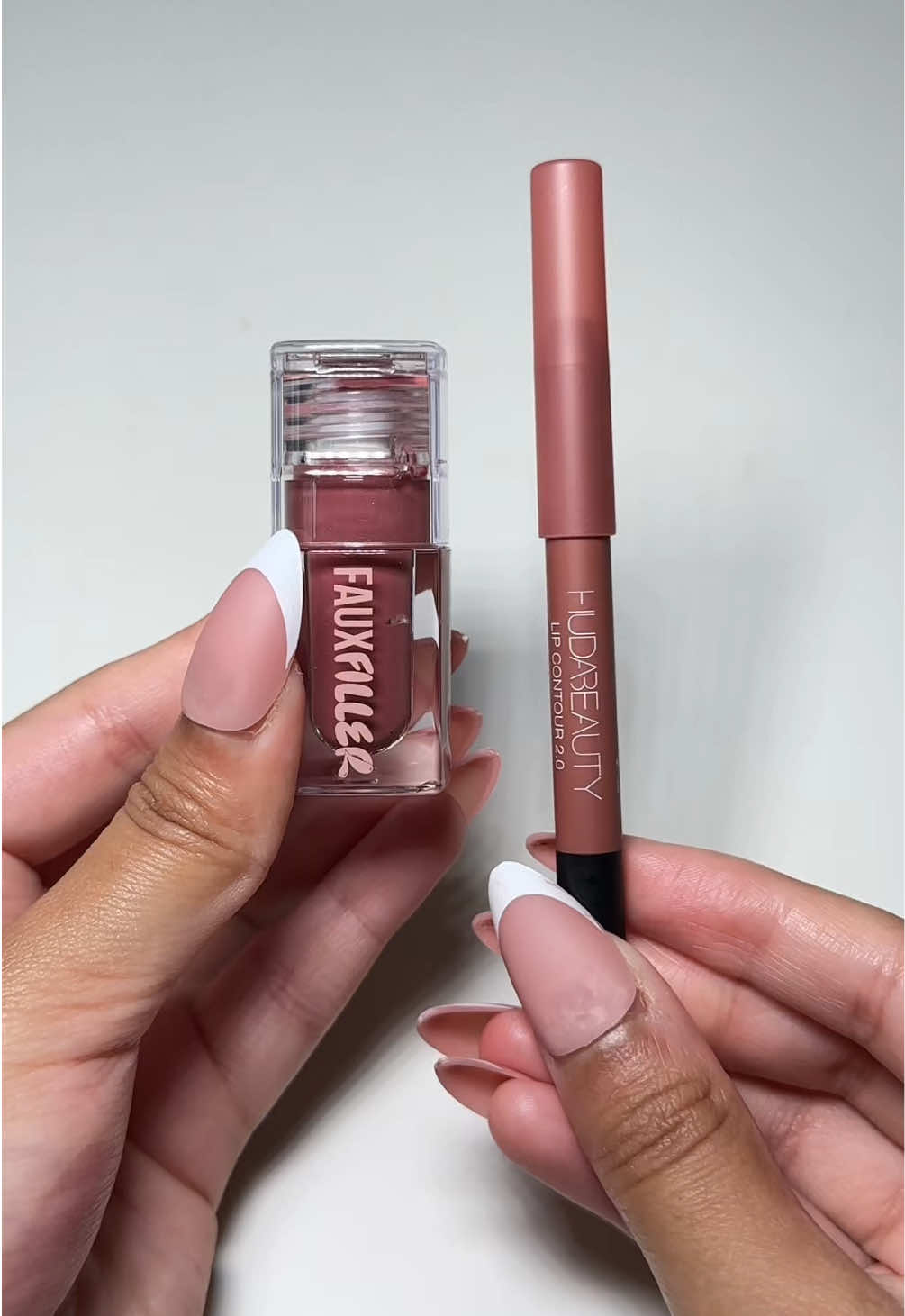 The lip combo that always gets me compliments 👄✨ This is your sign to grab THE most flattering @Huda Beauty lip combo 😍 💋 Lip Contour: Pinky Brown 💫 Faux Filler Gloss: Bombshell Perfectly plump, glossy, and wearable for any look! #hudabeauty #lipcombo #glossylips #bombshell #fauxfiller #pinkybrown #viralvideos 